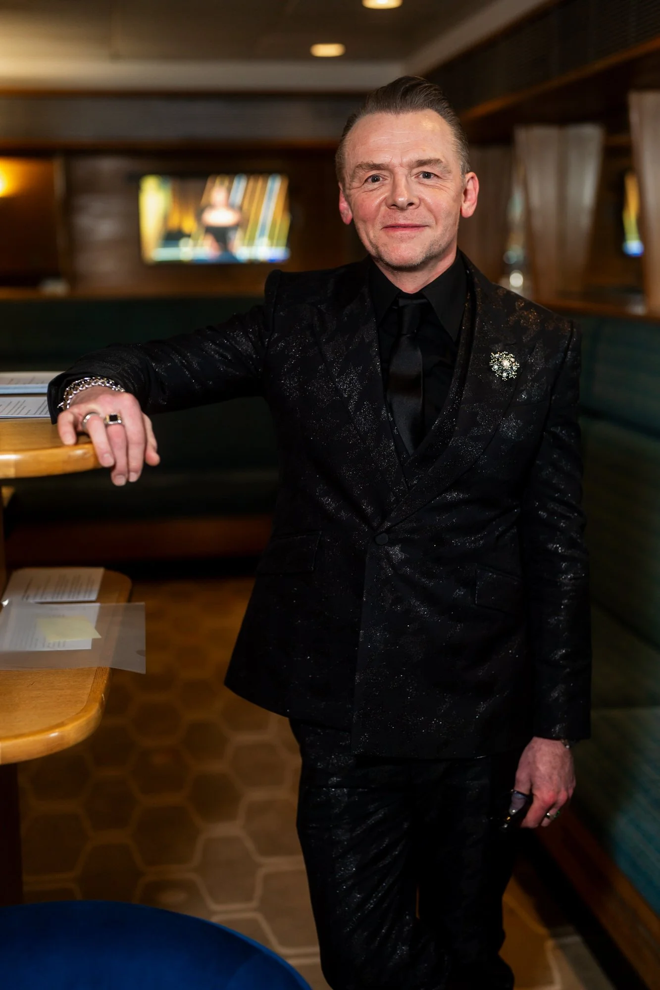Simon Pegg posing for John Clark backstage at the 2025 BAFTA Film Awards.