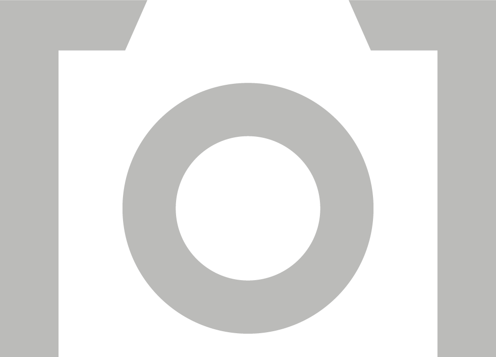 Silhouette of a camera with a large circular lens opening in the center.