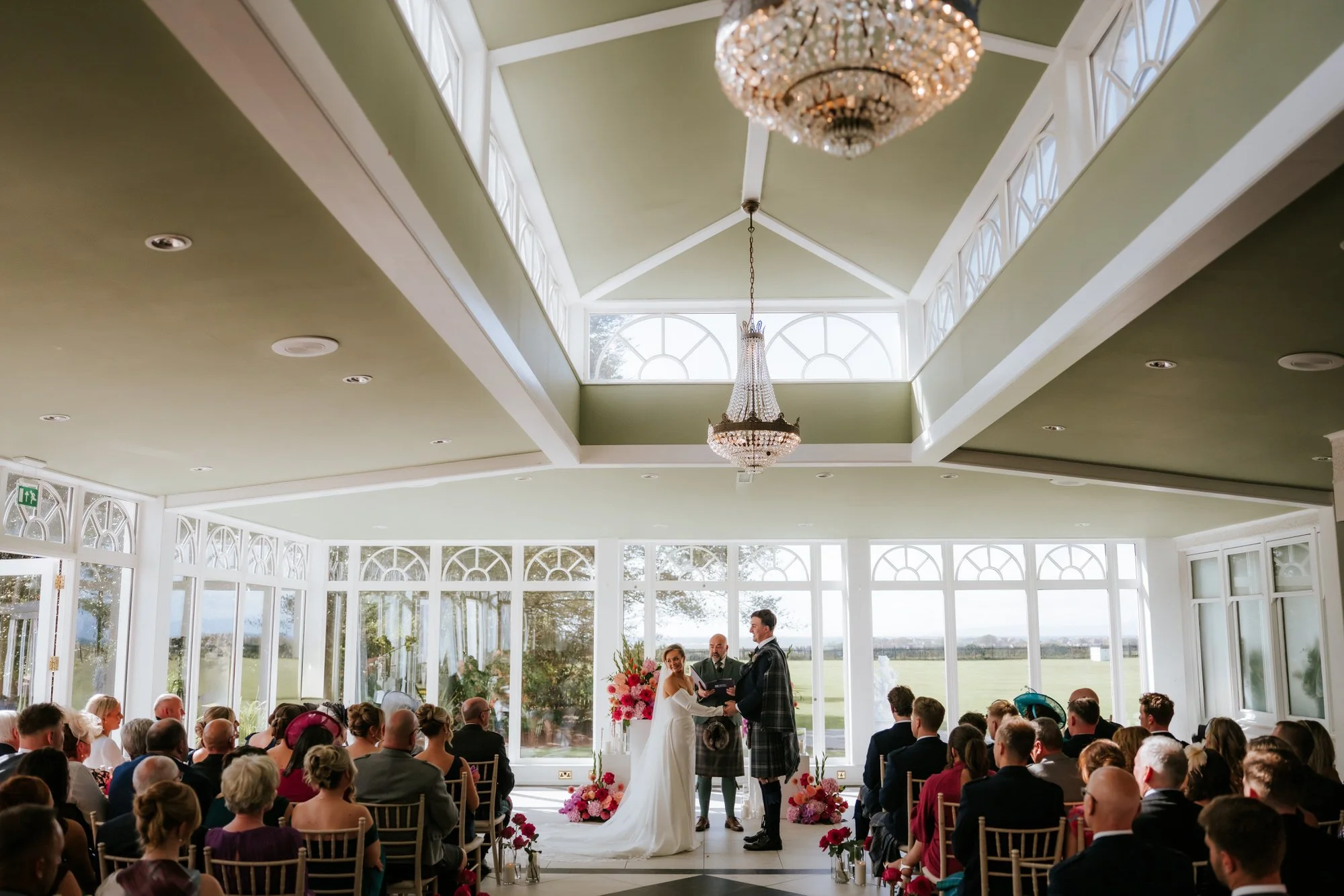 Fiona and Connor’s ceremony beneath Lochgreen’s skylight and chandelier.