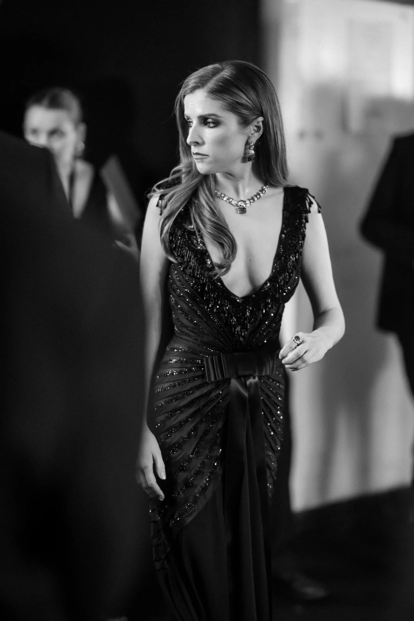 Anna Kendrick backstage at the 2025 BAFTA Film Awards, photographed in black and white.
