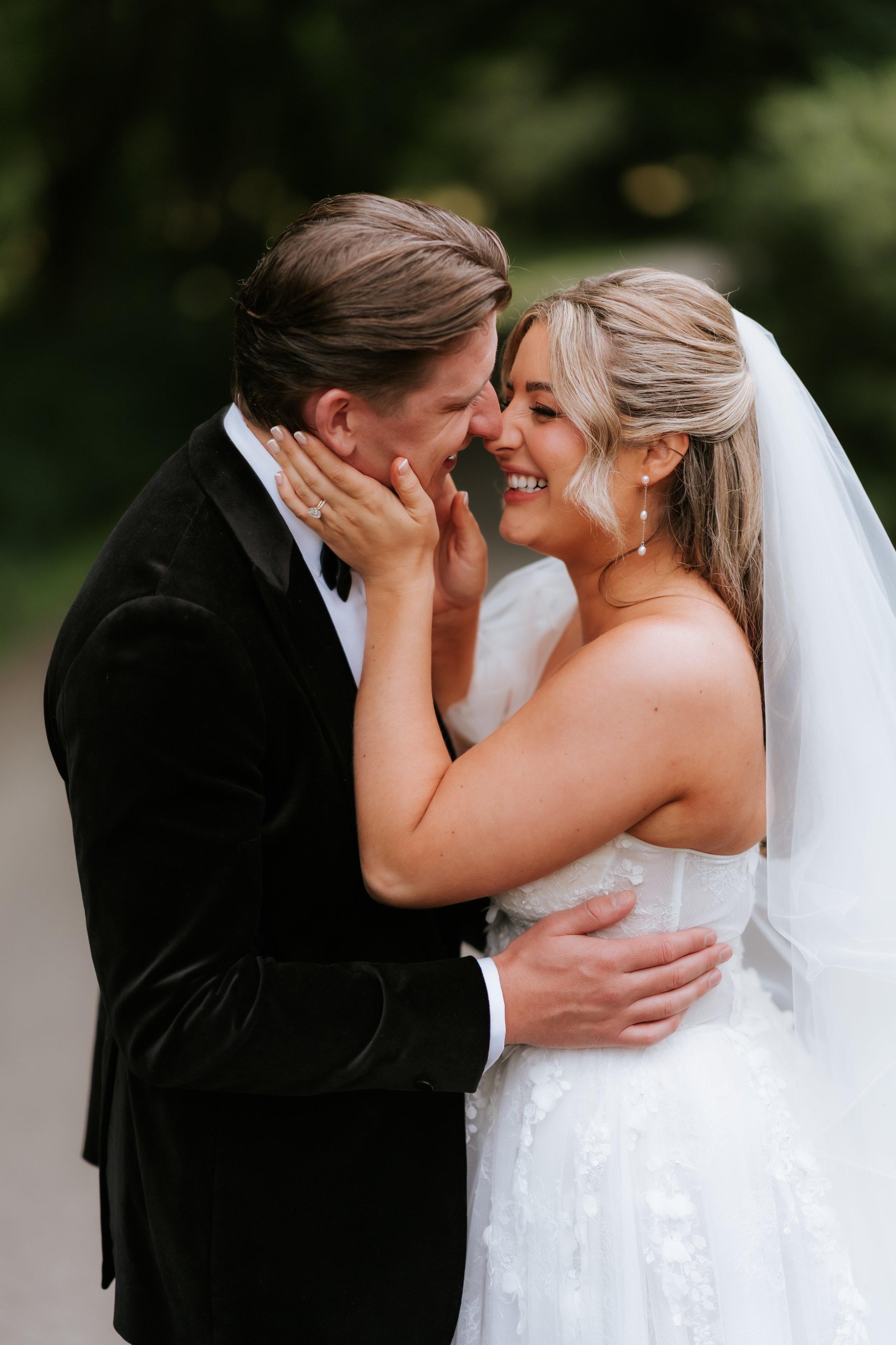 Emma and Frazer sharing a quiet embrace outdoors at Cornhill Castle.