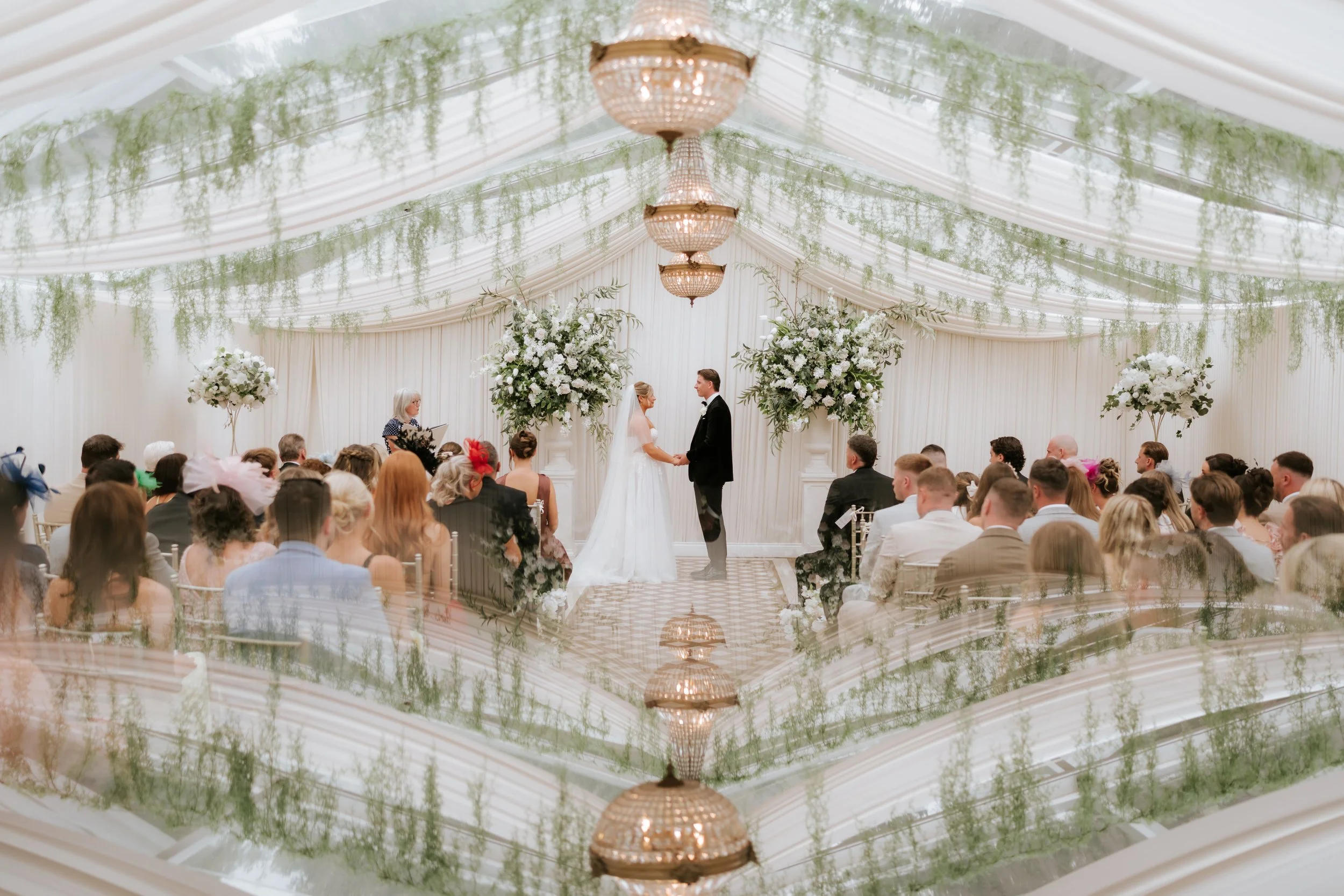 A reflection of Emma and Frazer’s ceremony beneath the pavilion chandeliers.