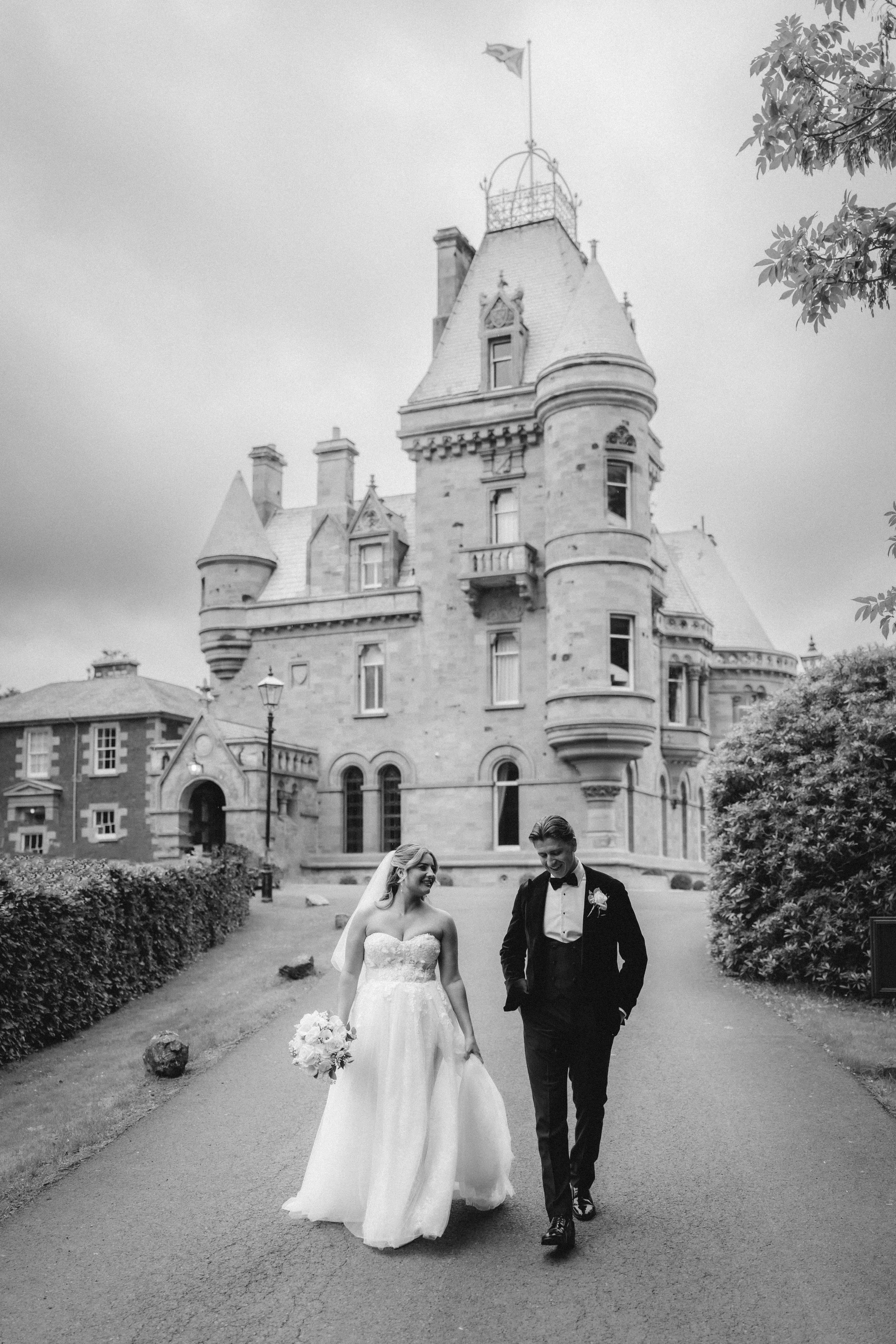 Black-and-white portrait of Emma and Frazer with Cornhill Castle’s tower behind them.