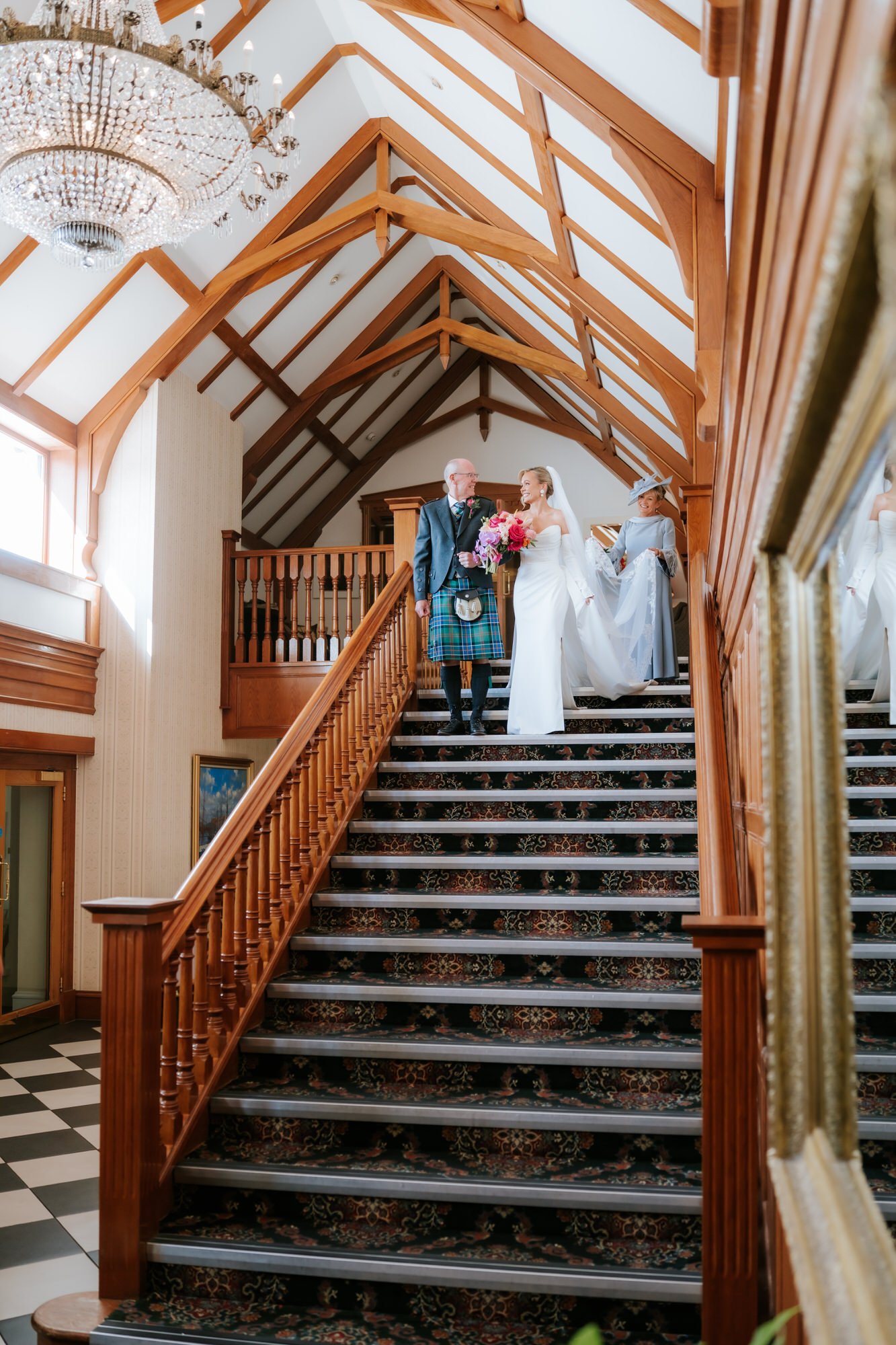 Fiona descending the wooden staircase at Lochgreen with her parents.