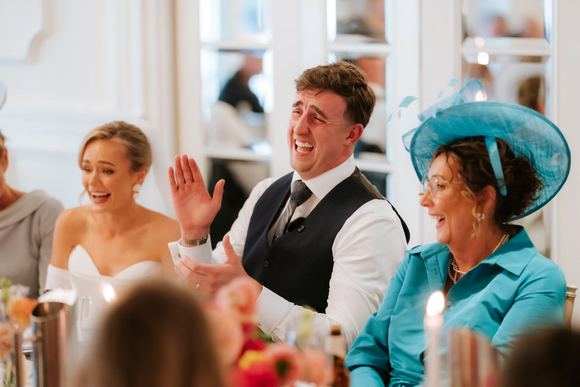 Laughter and applause at the top table during the speeches.