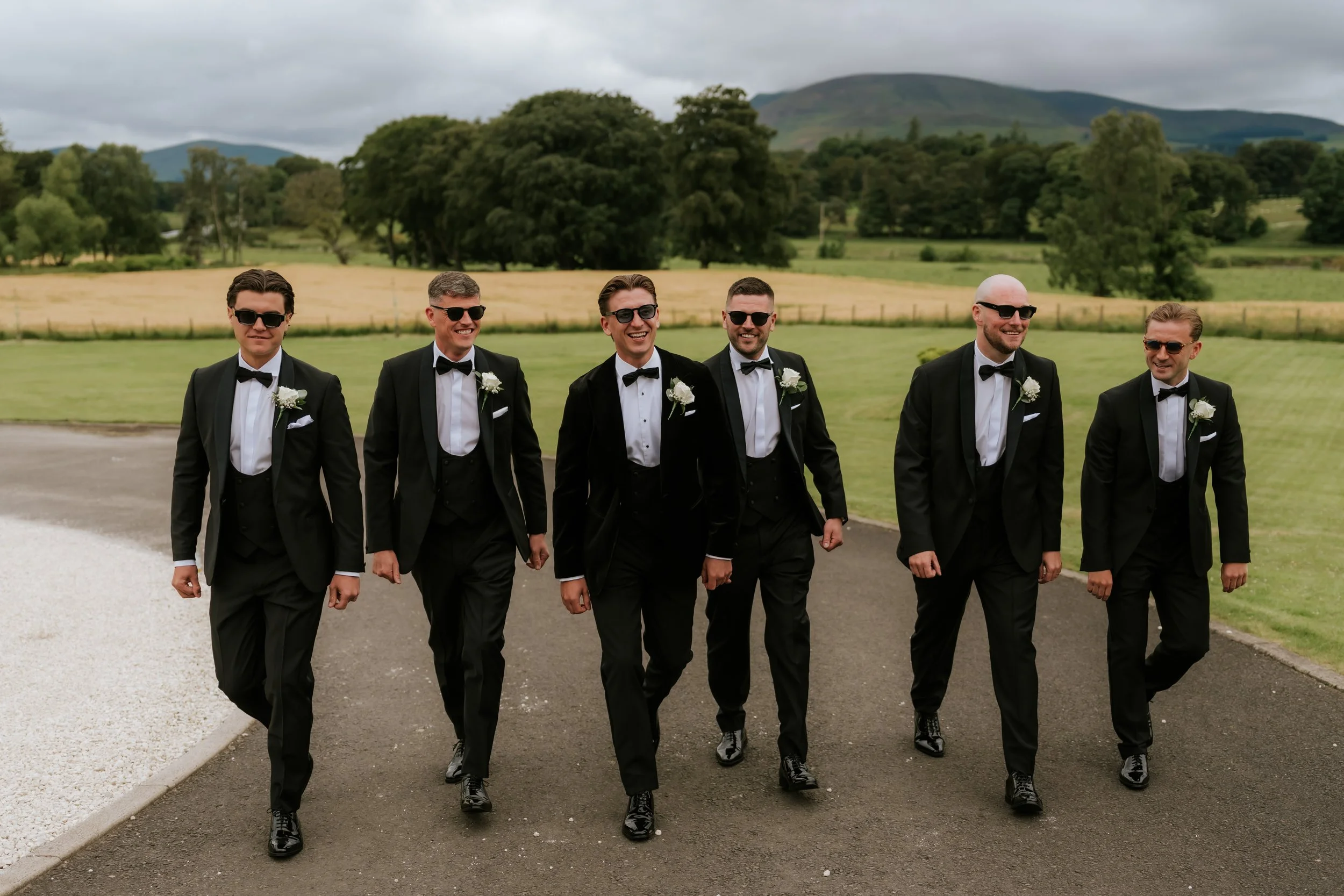 Frazer and his groomsmen outside Cornhill Castle with the countryside behind them.
