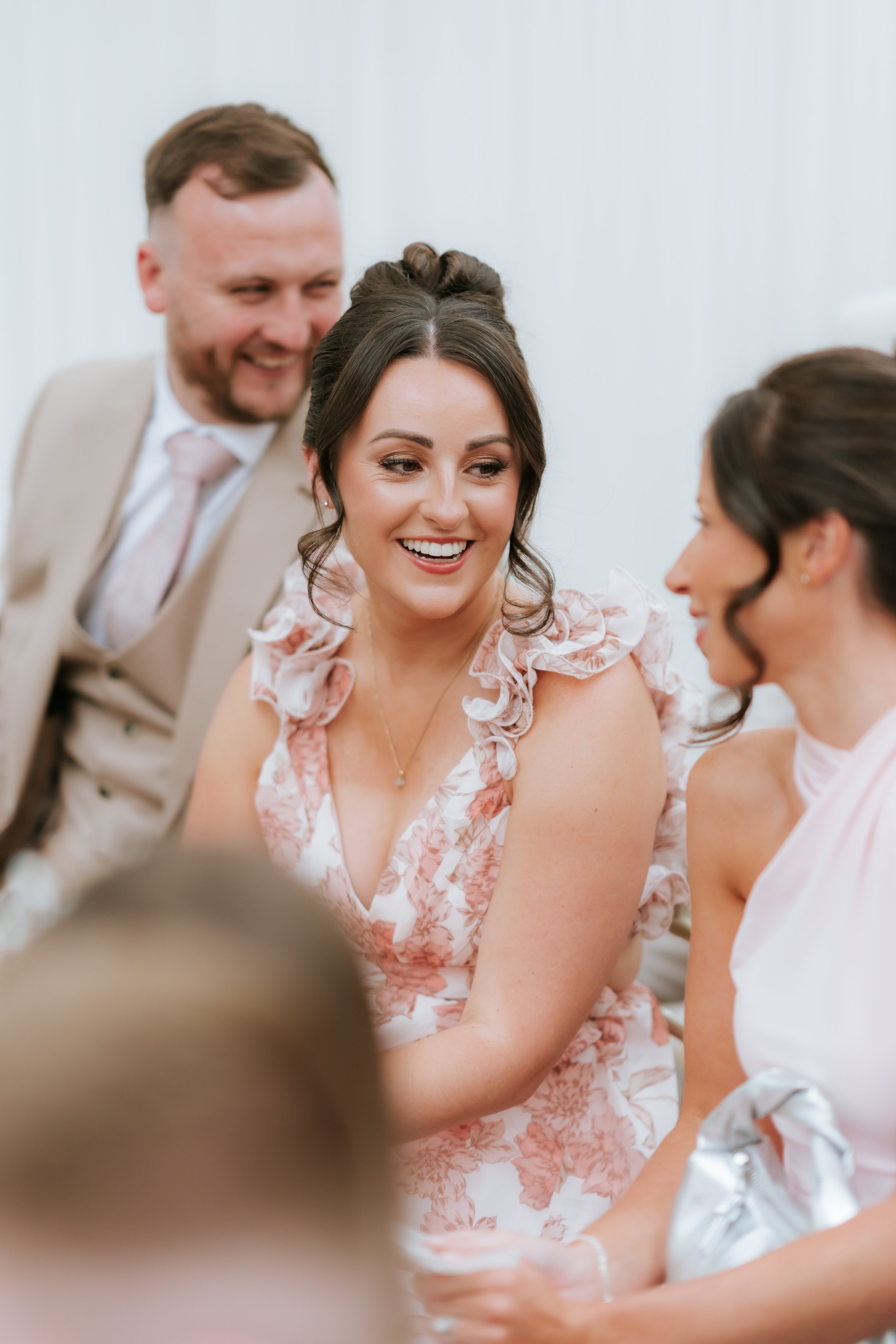 A candid smile from a guest during Emma and Frazer’s wedding celebrations.