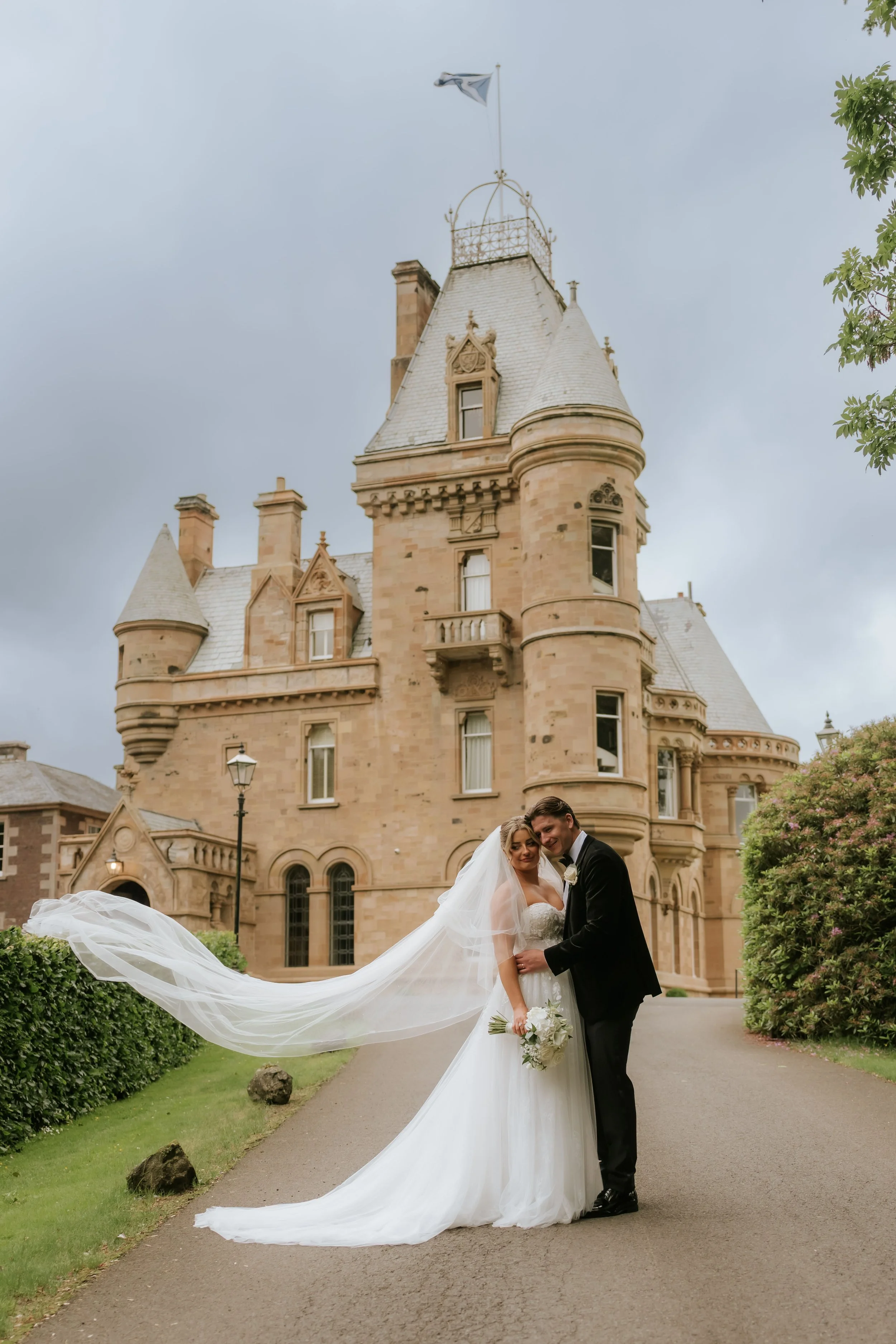 Emma’s veil flowing beside Frazer with Cornhill Castle behind them.