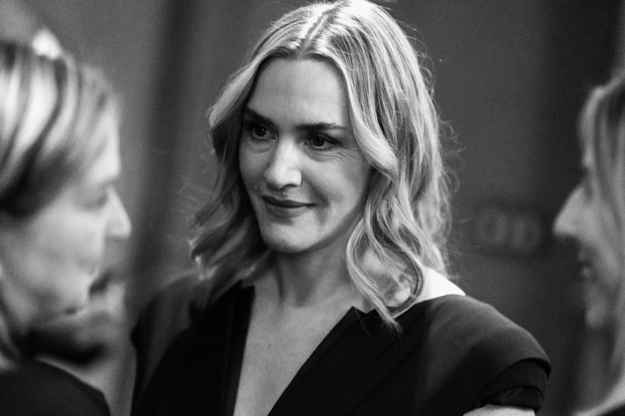 Kate Winslet looking towards her husband in the BAFTA green room, photographed in black and white.