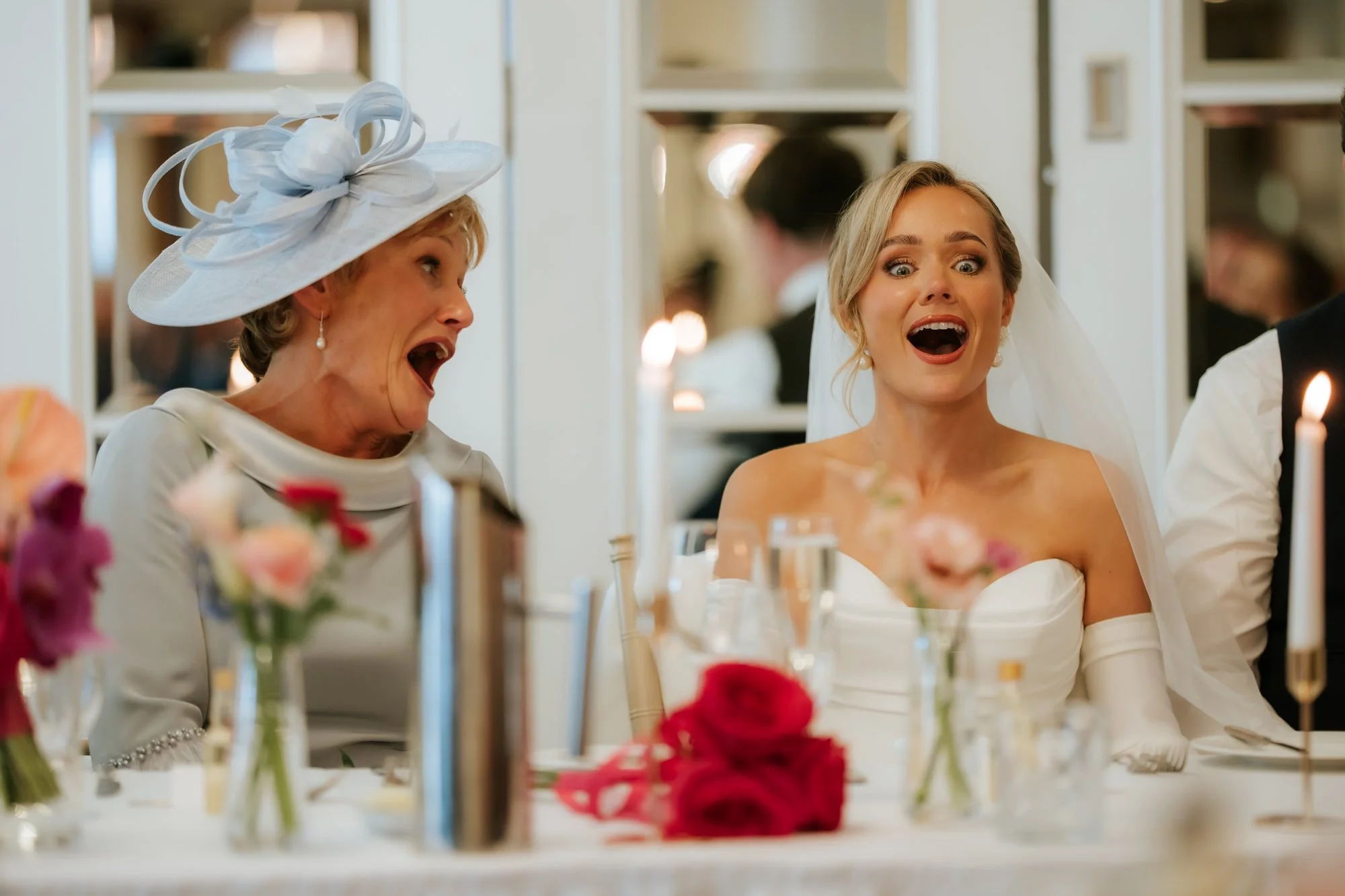Fiona and a guest reacting with surprise during the wedding speeches.