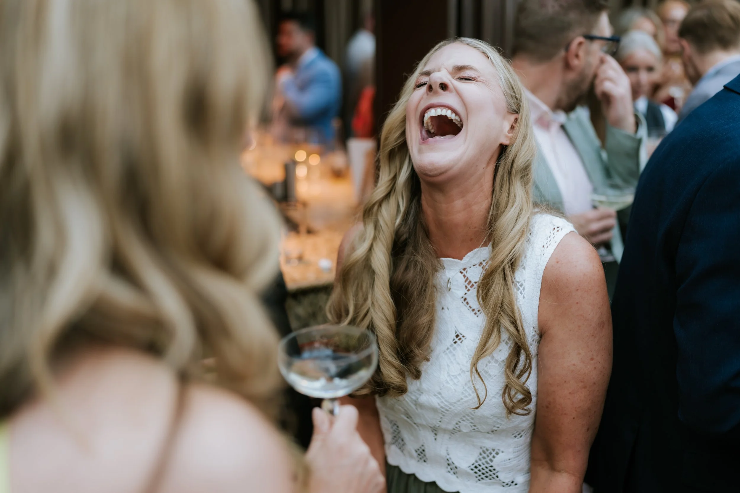 A wedding guest laughing during the Cornhill Castle reception.