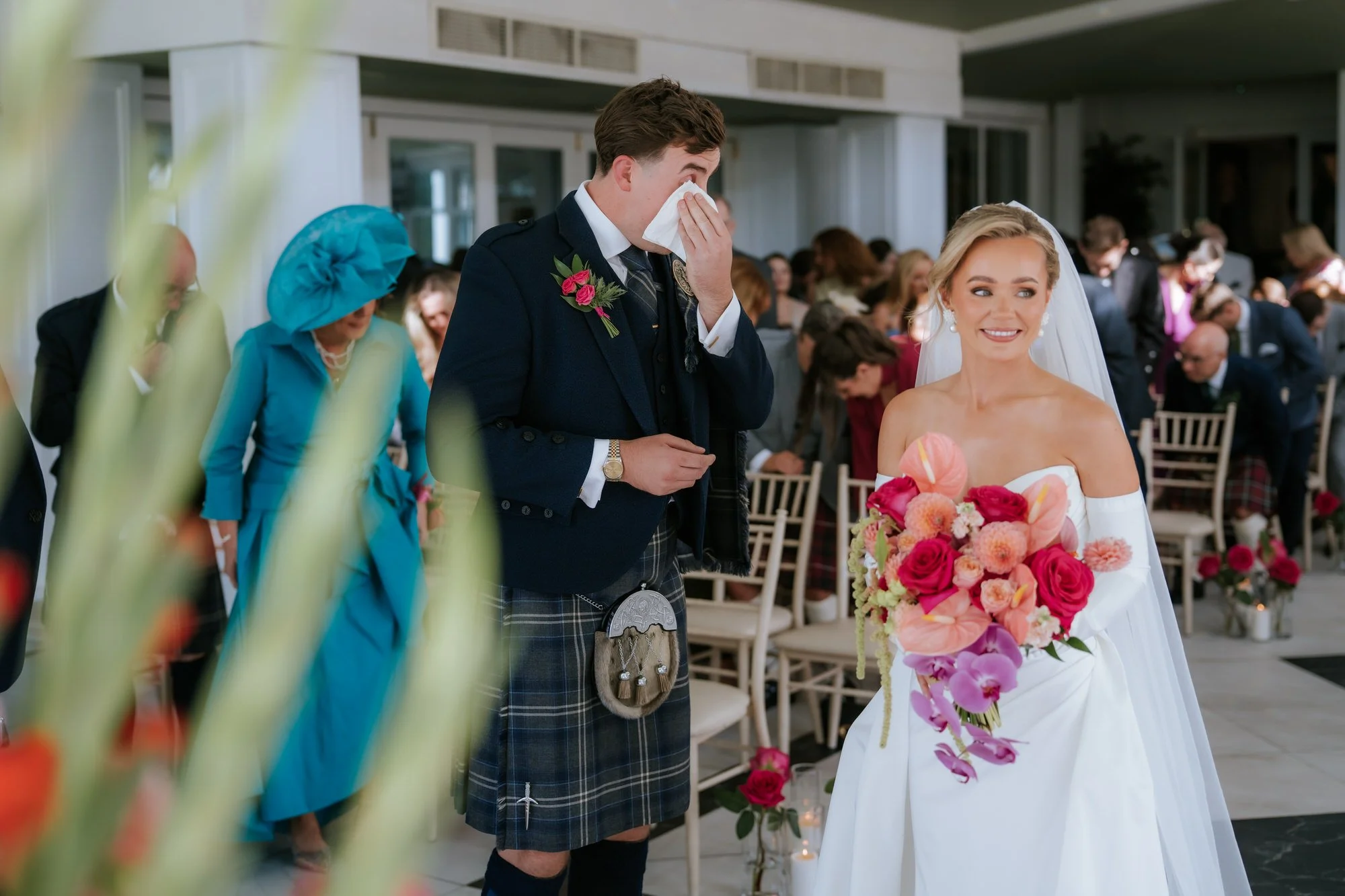 Connor wiping away a tear beside Fiona during the ceremony.