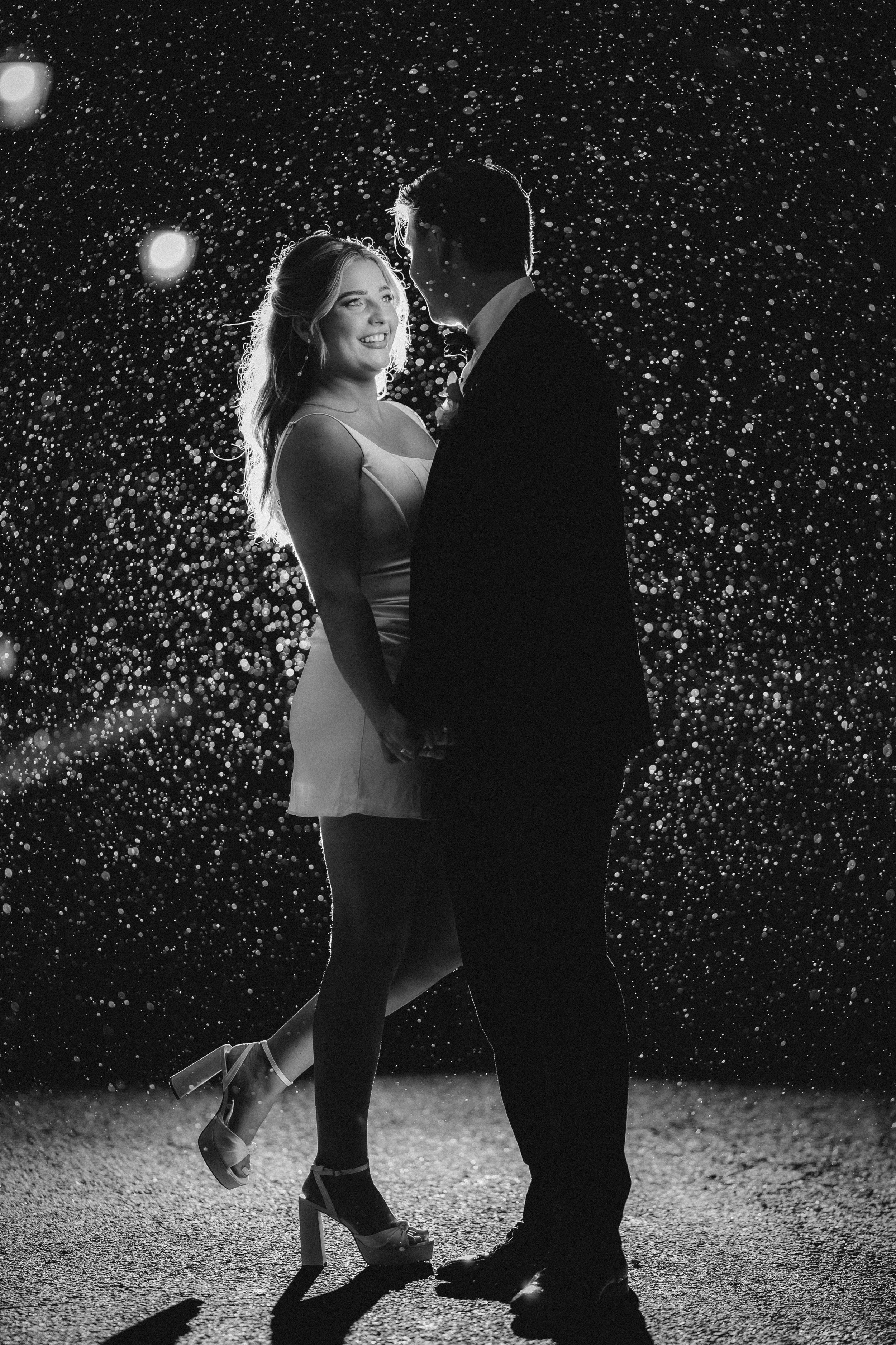 Emma and Frazer celebrating with a champagne spray at the end of their Cornhill Castle wedding.