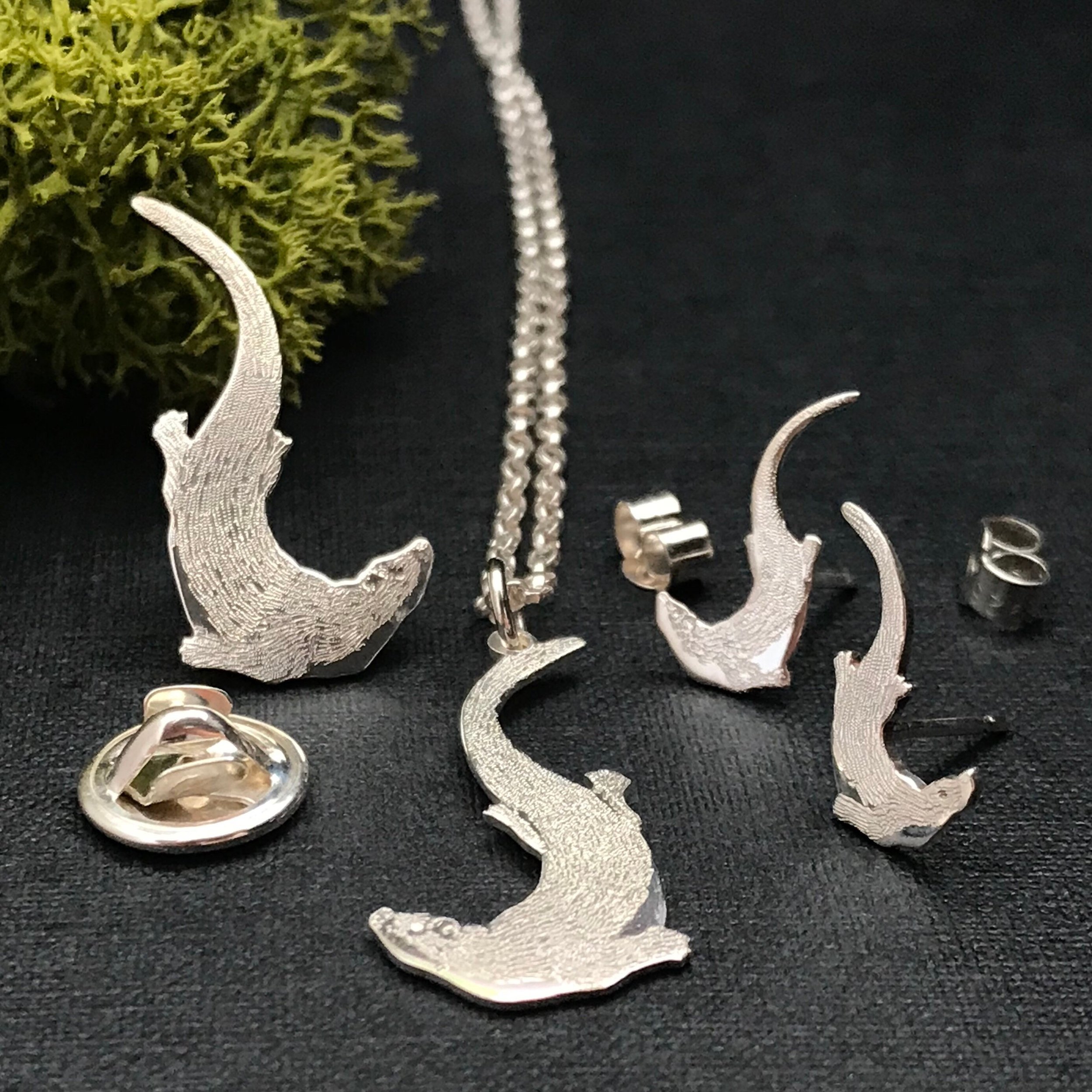 sterling silver swimming otter jewellery, pendant, stud, earrings and pin.