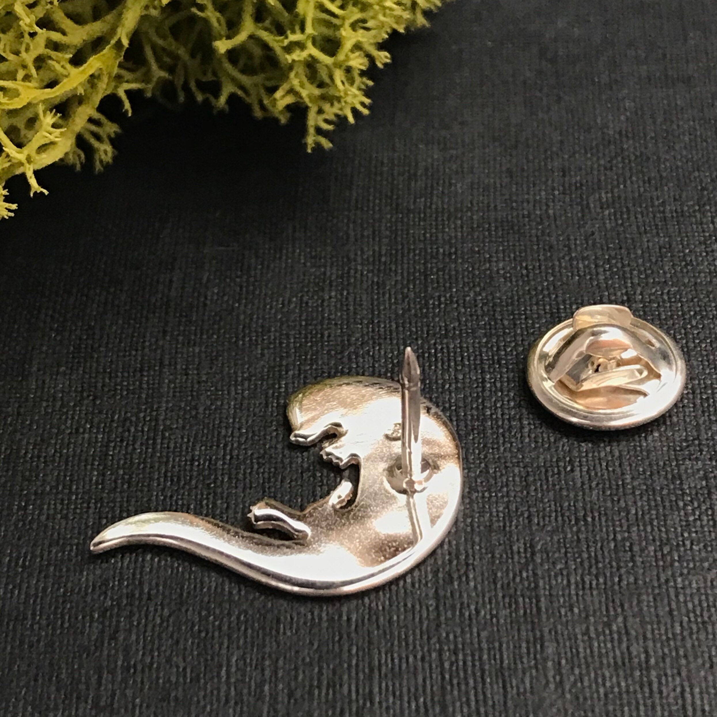 Back of Playing Otter lapel pin.