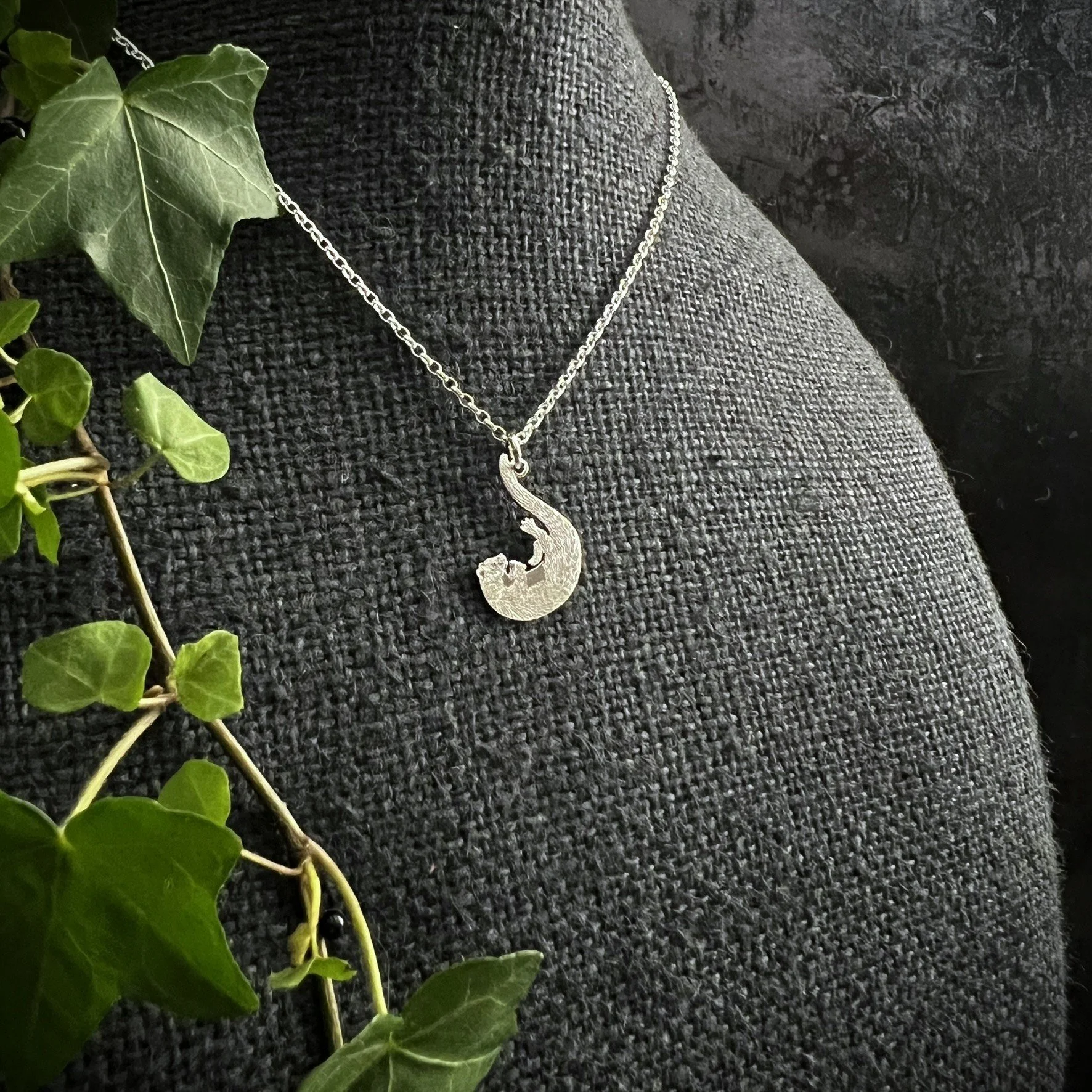 OTTER PENDANT PLAYING.JPEG
