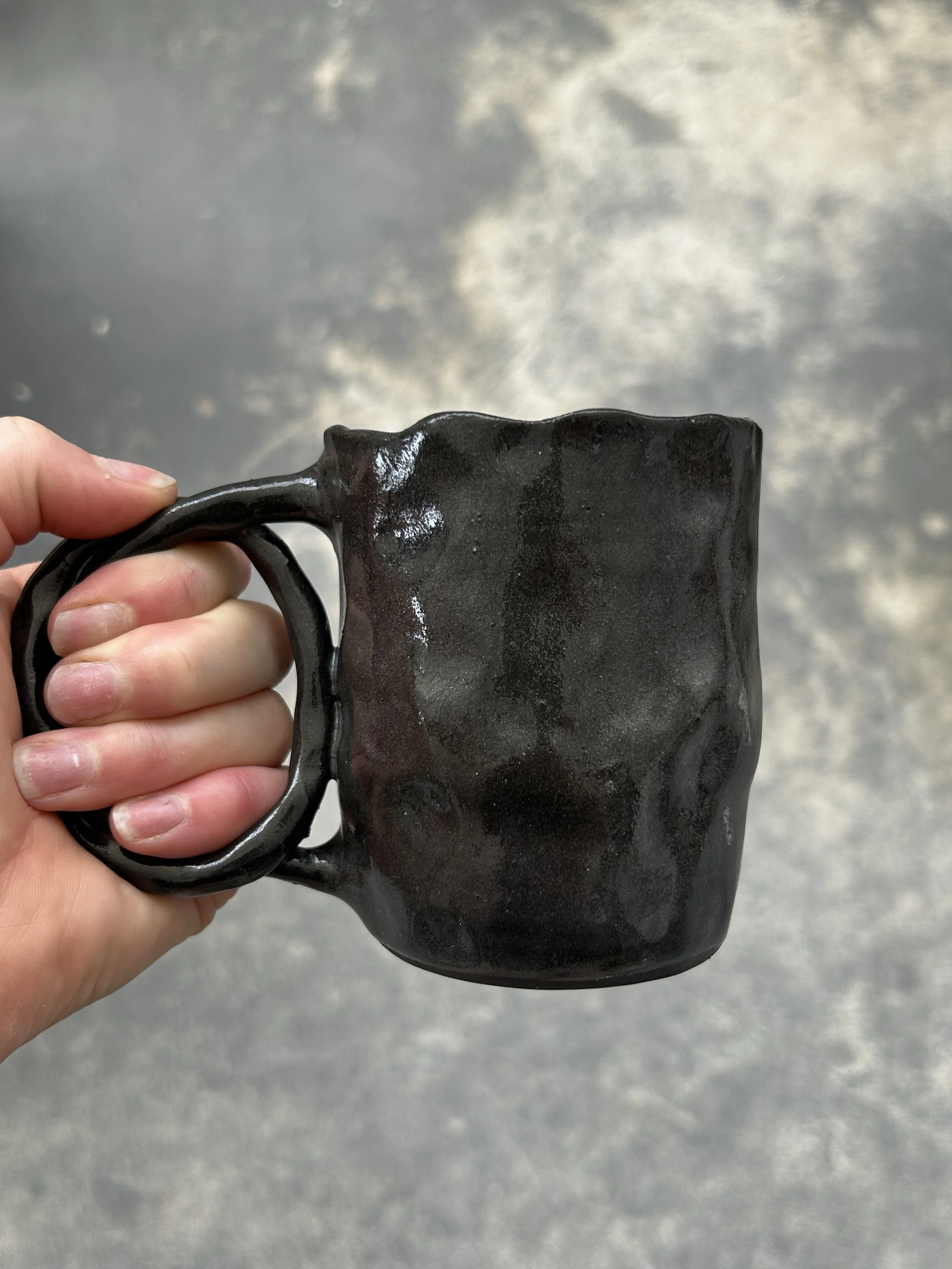 Pinched black pretzel mug