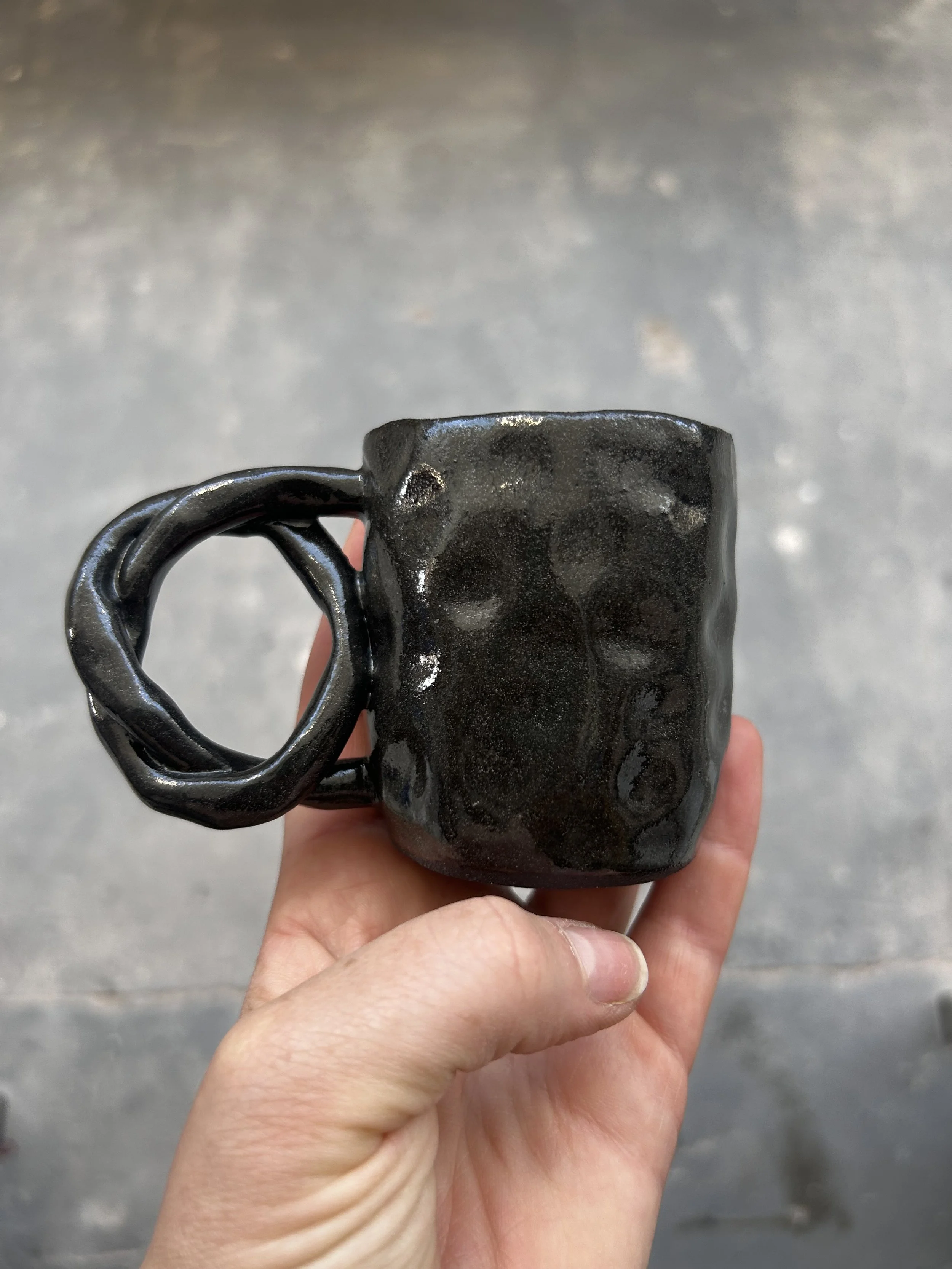 Pinched black pretzel espresso mug