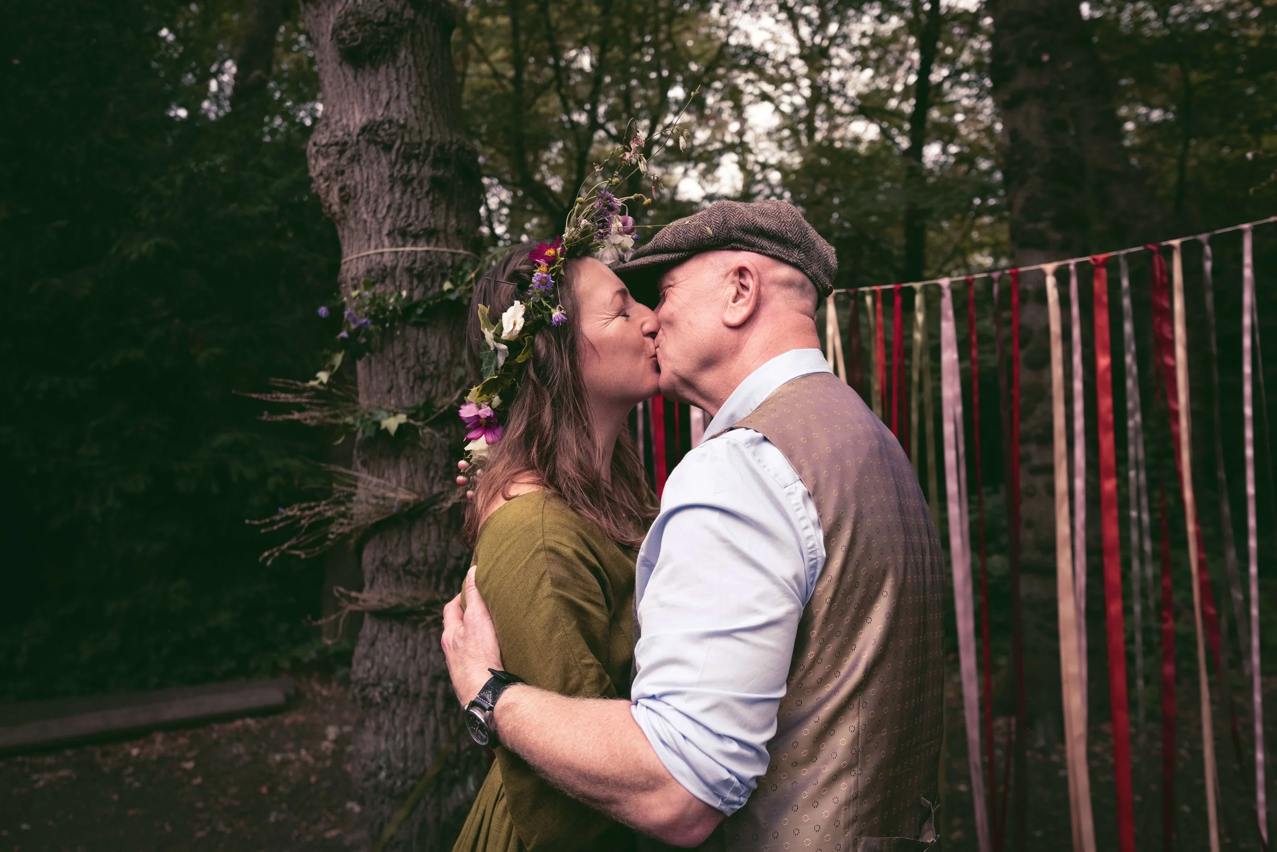 Forest husband and wife kiss