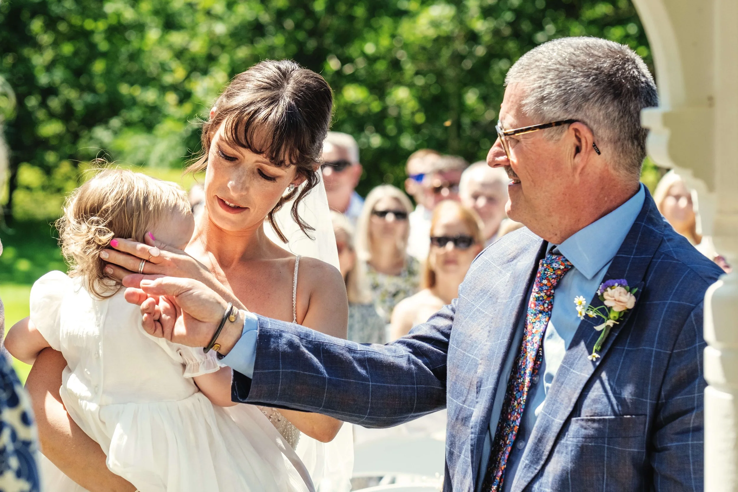 father of the bride with bride and grandchild