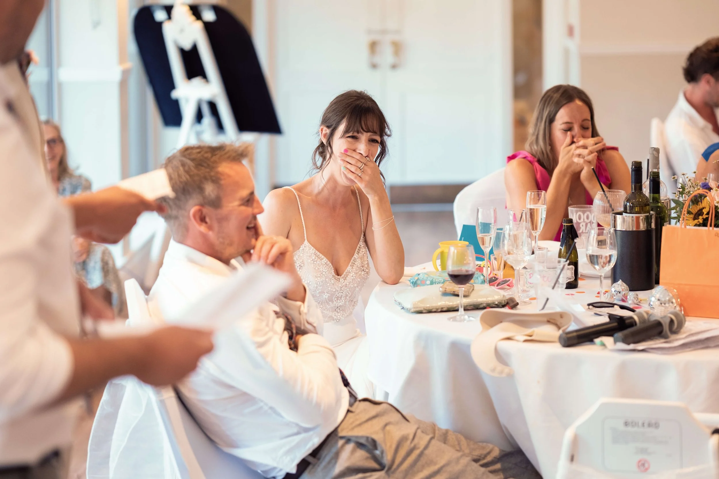 Bride laughs during best man speech