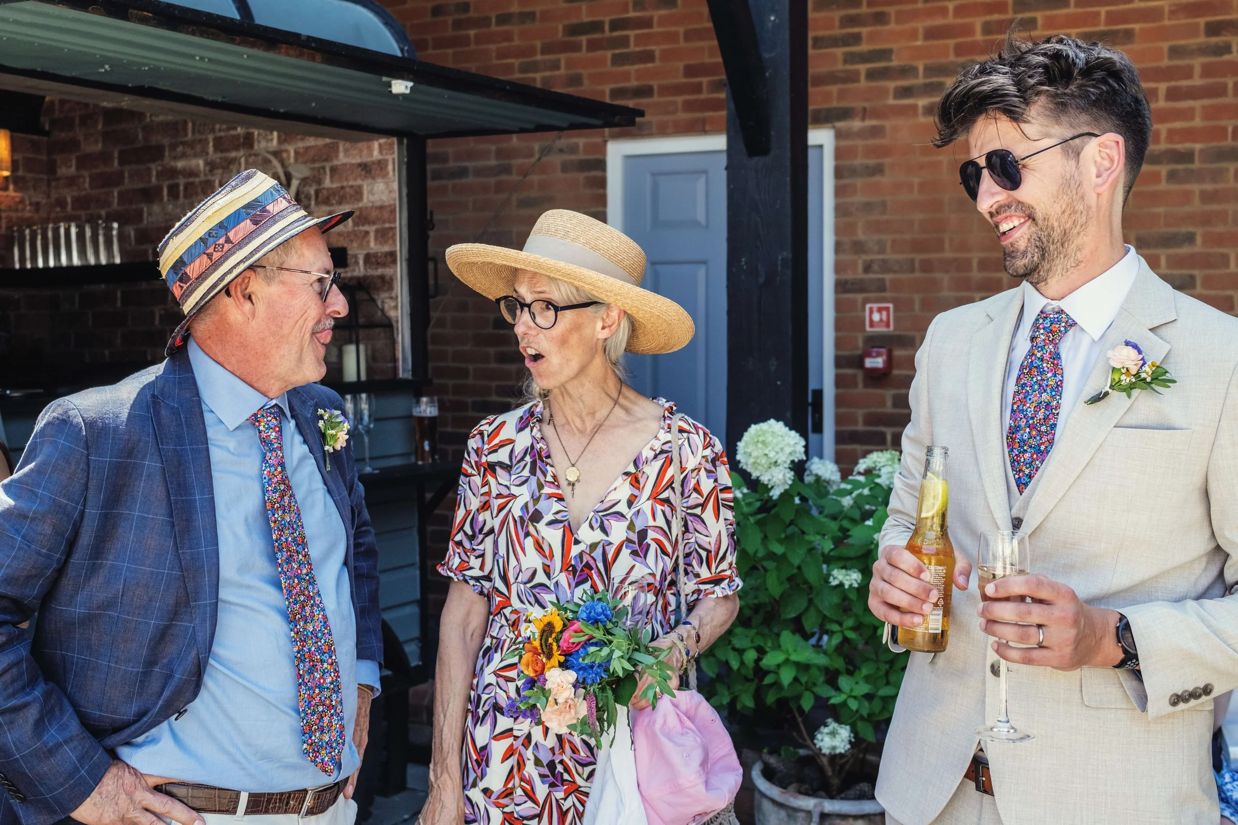 Mother and Father of the bride share a joke with best man