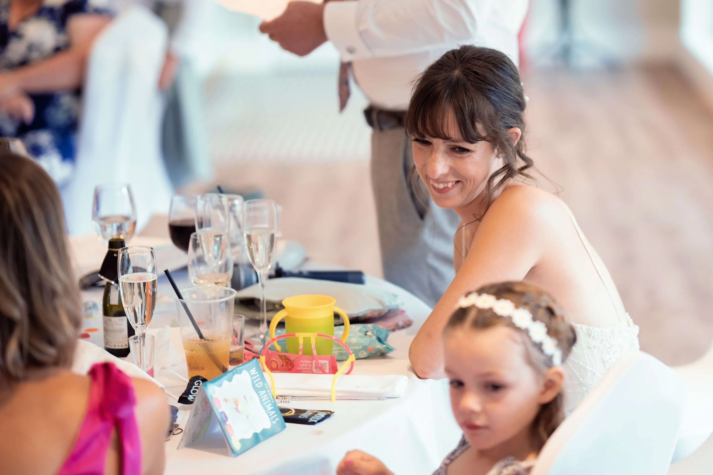 Bride looks lovingly at daughter