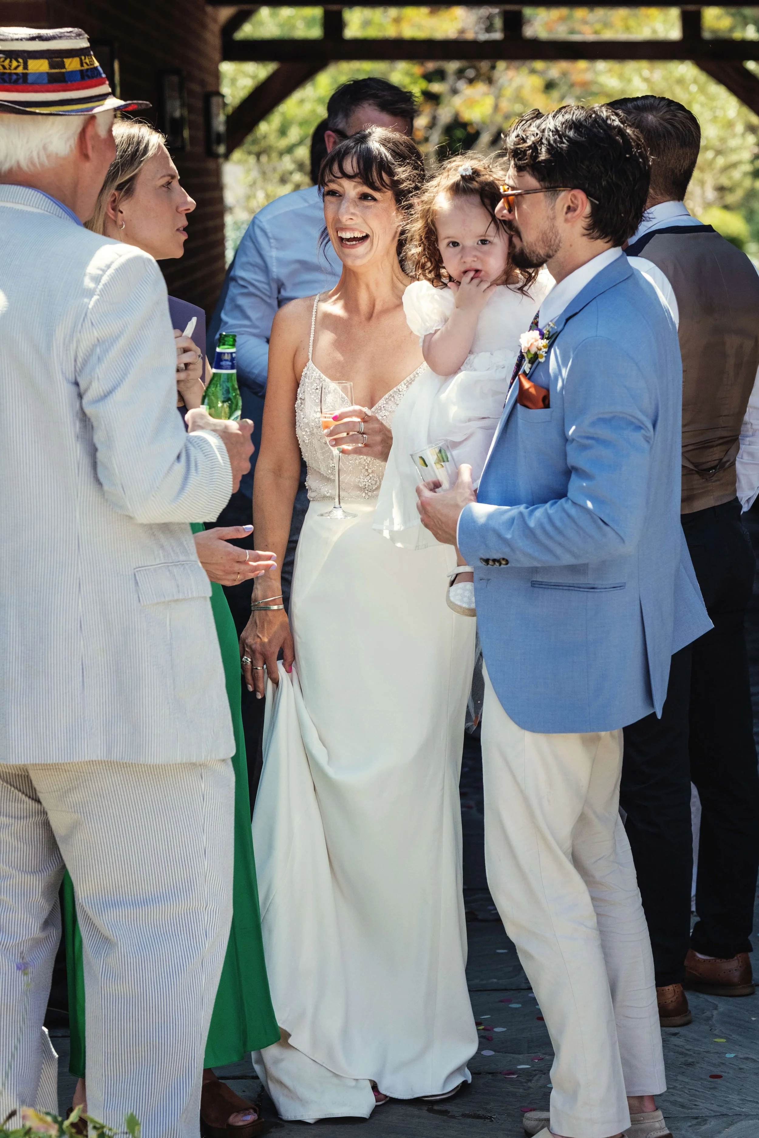 Smiling bride meets wedding guests and family