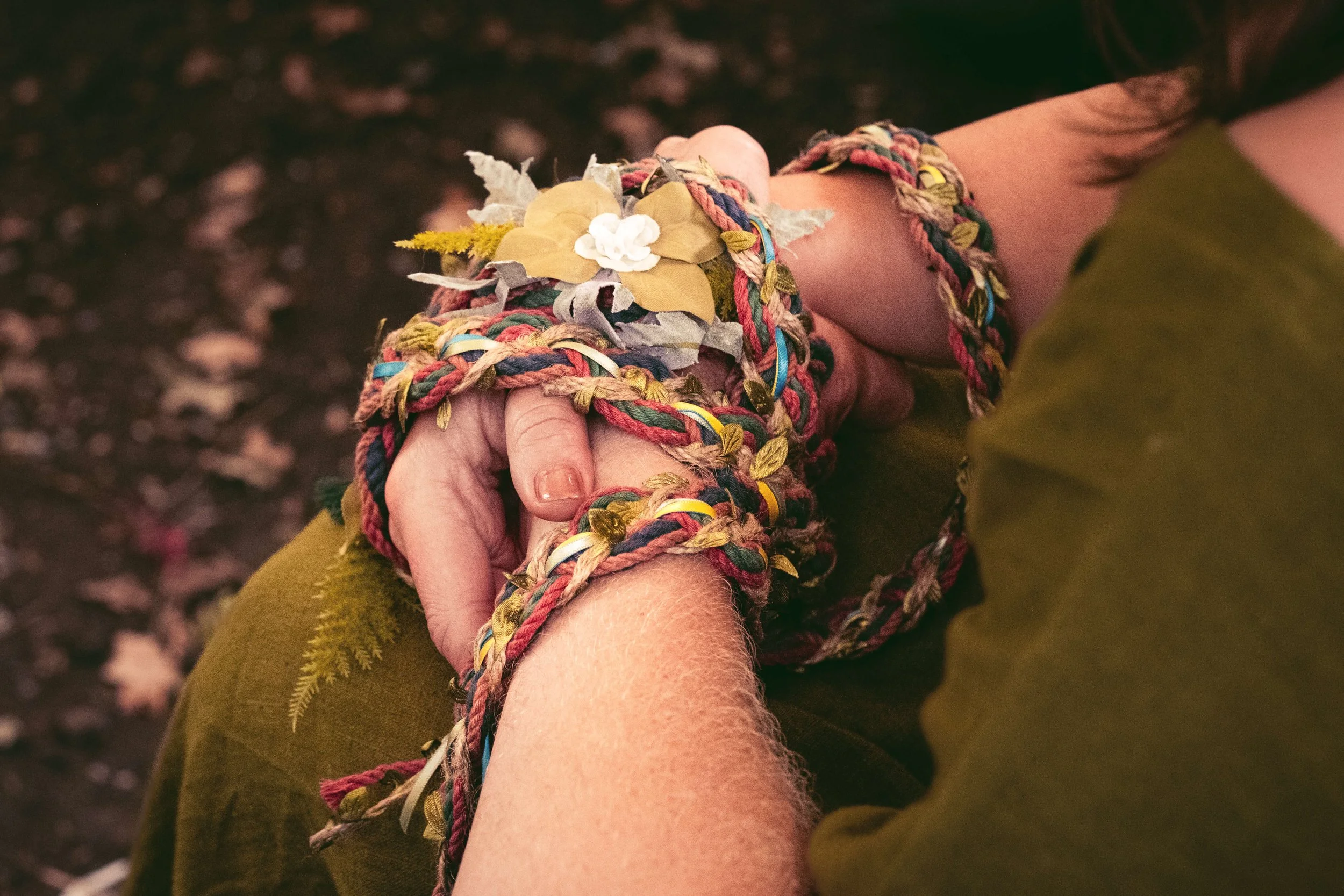 Hand fasting hands bound with ribbons