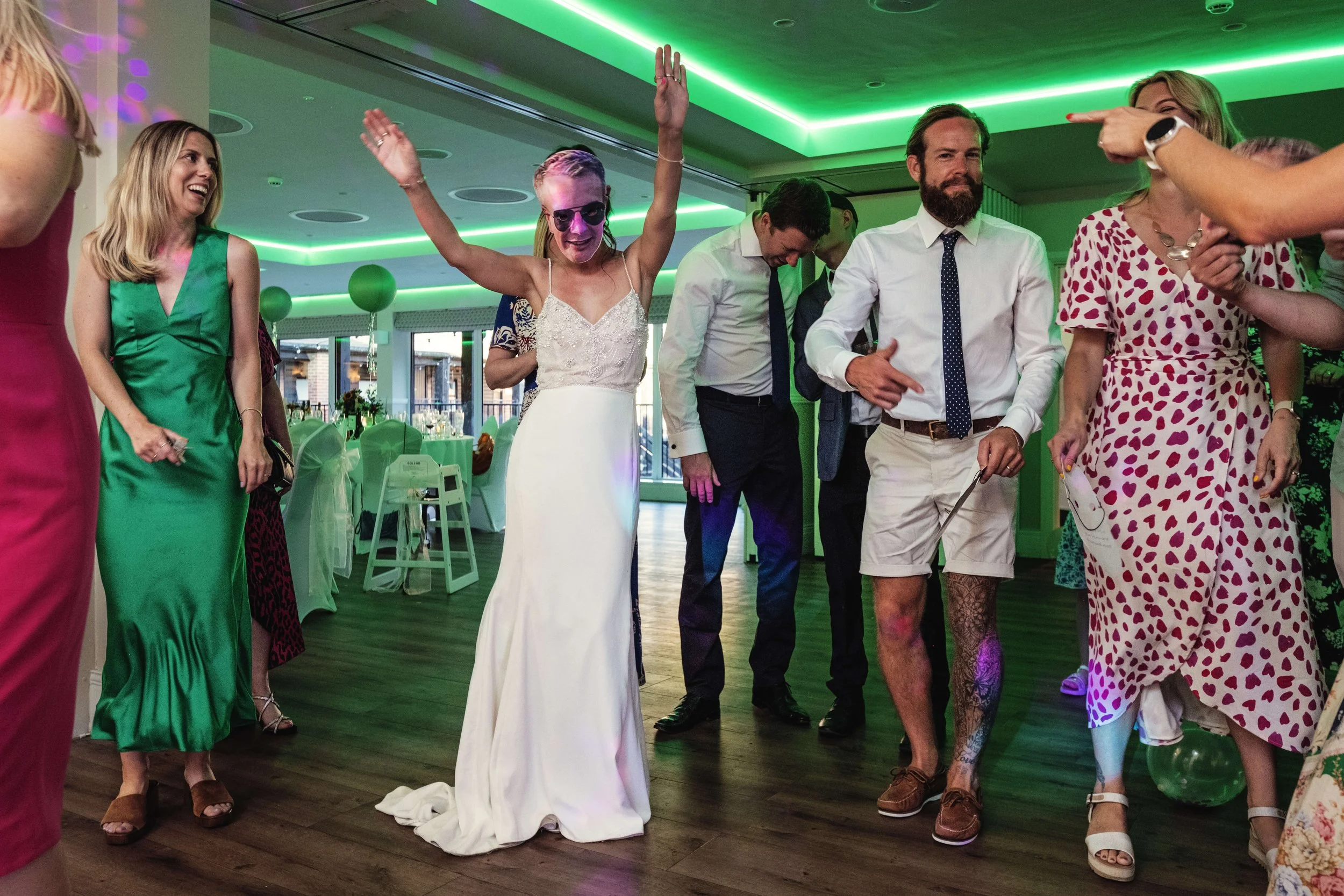 Bride dances wearing a groom mask