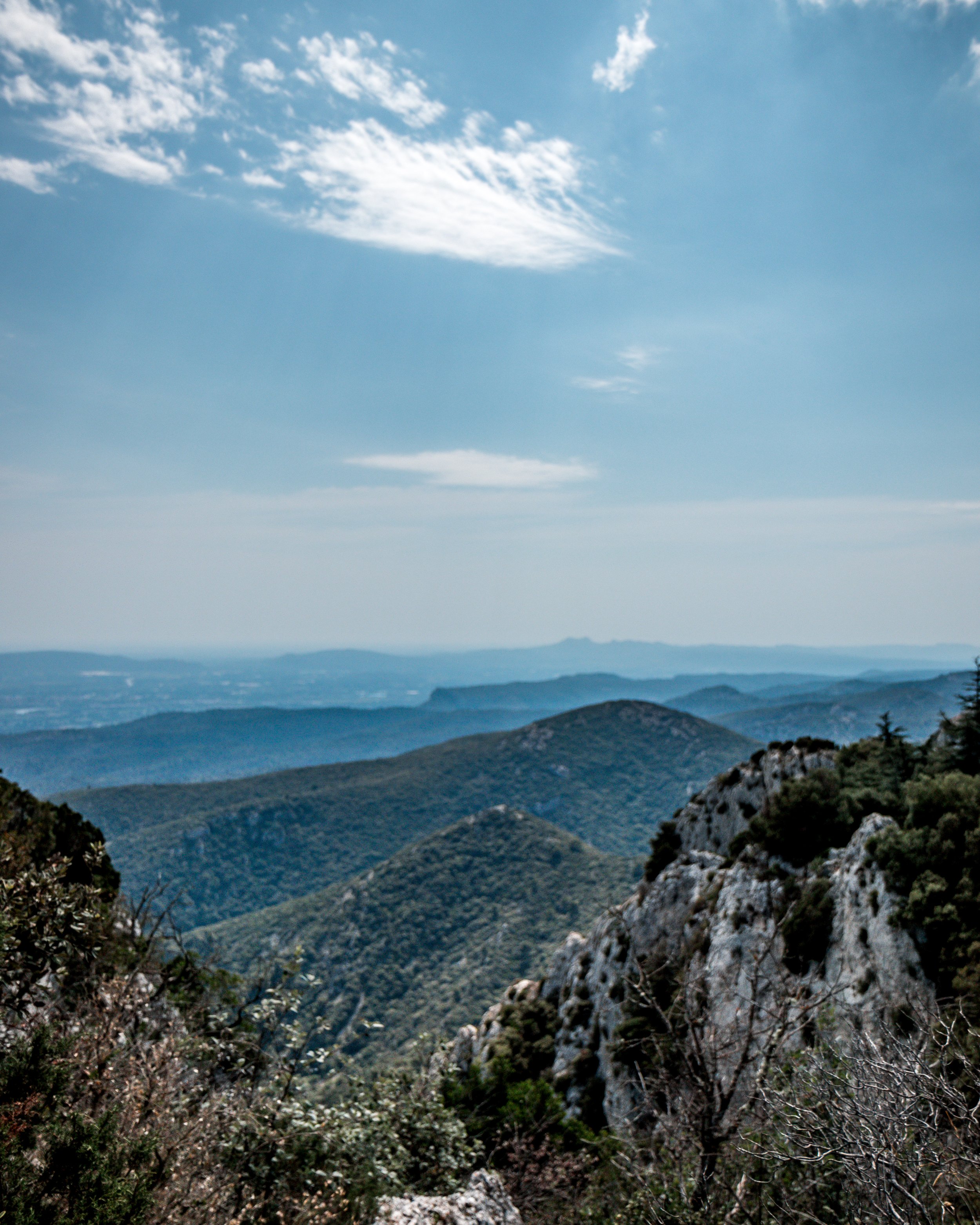Scenic view of rolling green mountains with a partly cloudy sky overhead.