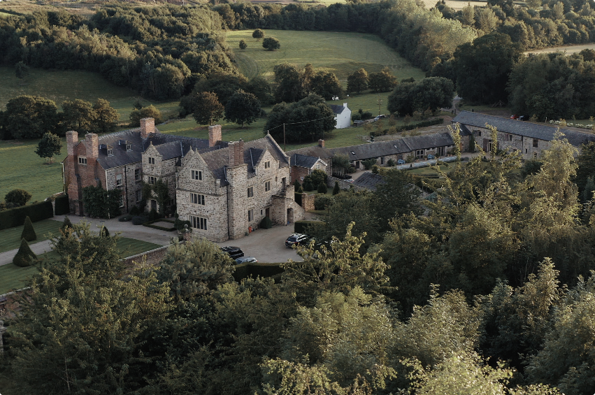 The historic house, stone barns and grounds at The Courtyard Venue near Oswestry.