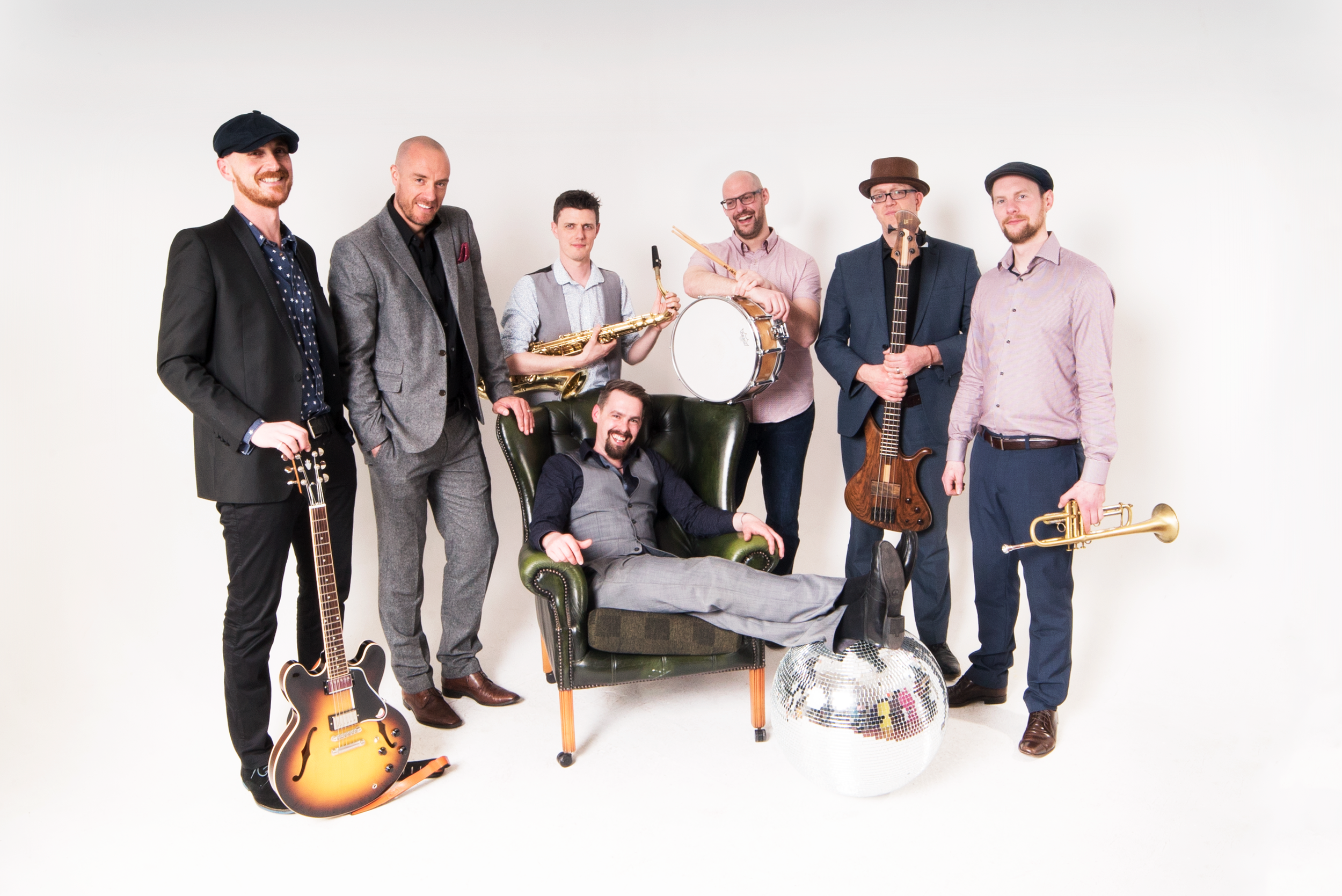 Makle fronted wedding party band in shropshire pose with a discoball