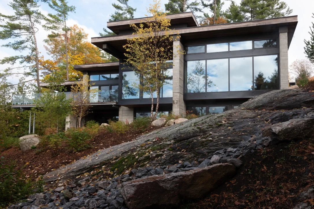 Modern cottage with windows in a forest