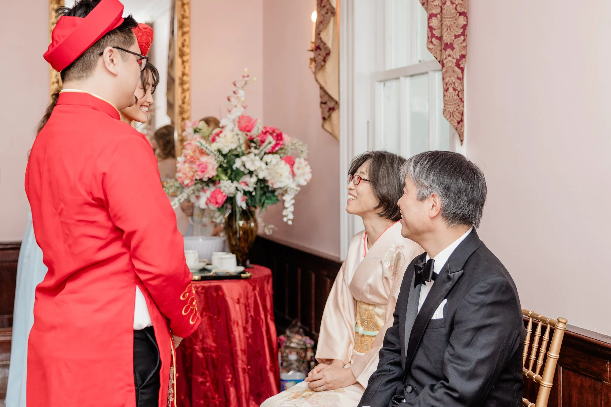 Bride & groom in traditional Vietnamese ao dai for Wedding Tea Ceremony with Japanese parents in kimono at Raspberry Plain Manor in Leesburg, VA