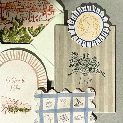 Collection of stationery and decorative paper items including a card with a floral design, a paper with a hand-drawn face in a blue and white border, a card with a red and white building sketch, and a border featuring small drawings of boats and drinks.