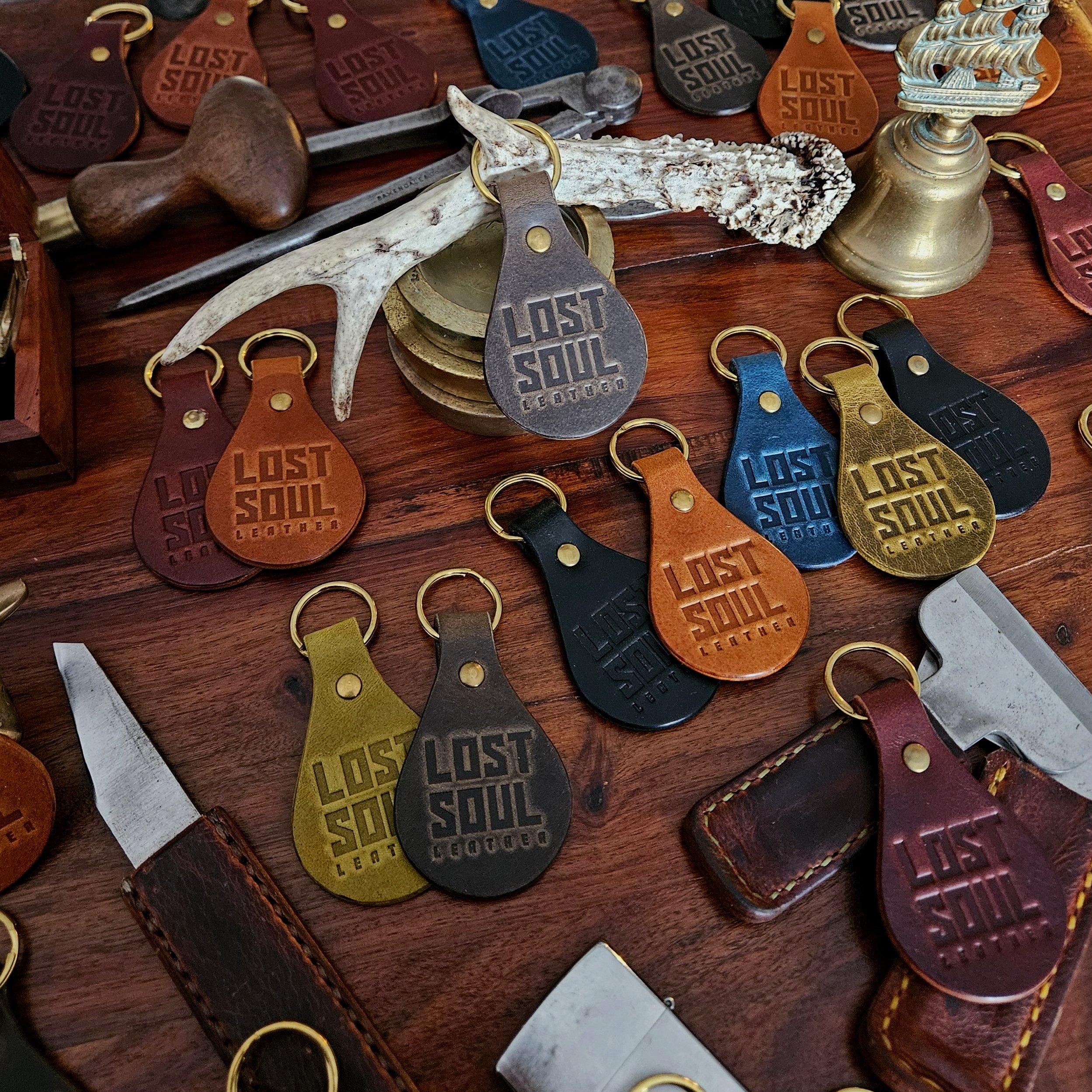Banded key fobs and merchandise. Vegetable tanned leather. Stamped. Solid brass fittings. One of a kind. Merchandise.