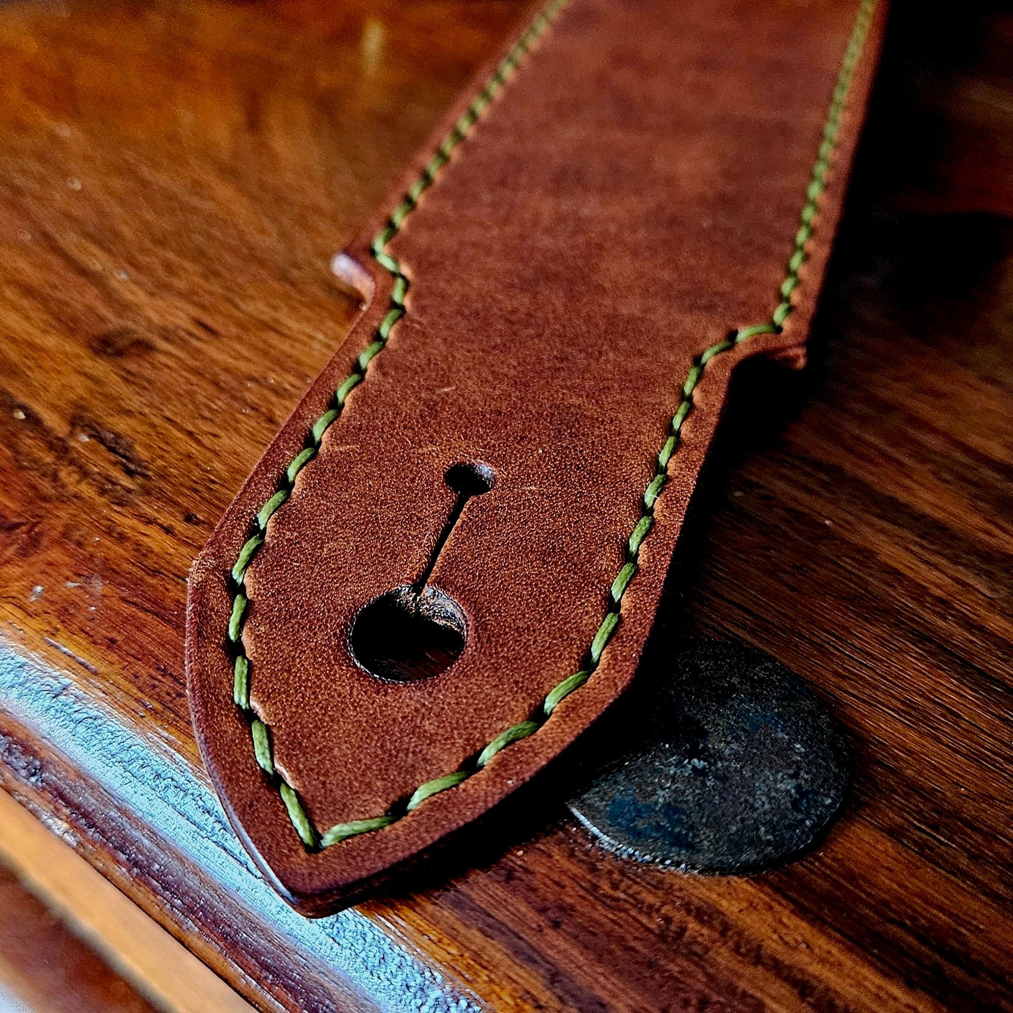 Hand made leather guitar strap. Hand stitched. Solid brass buckle. Made in UK.