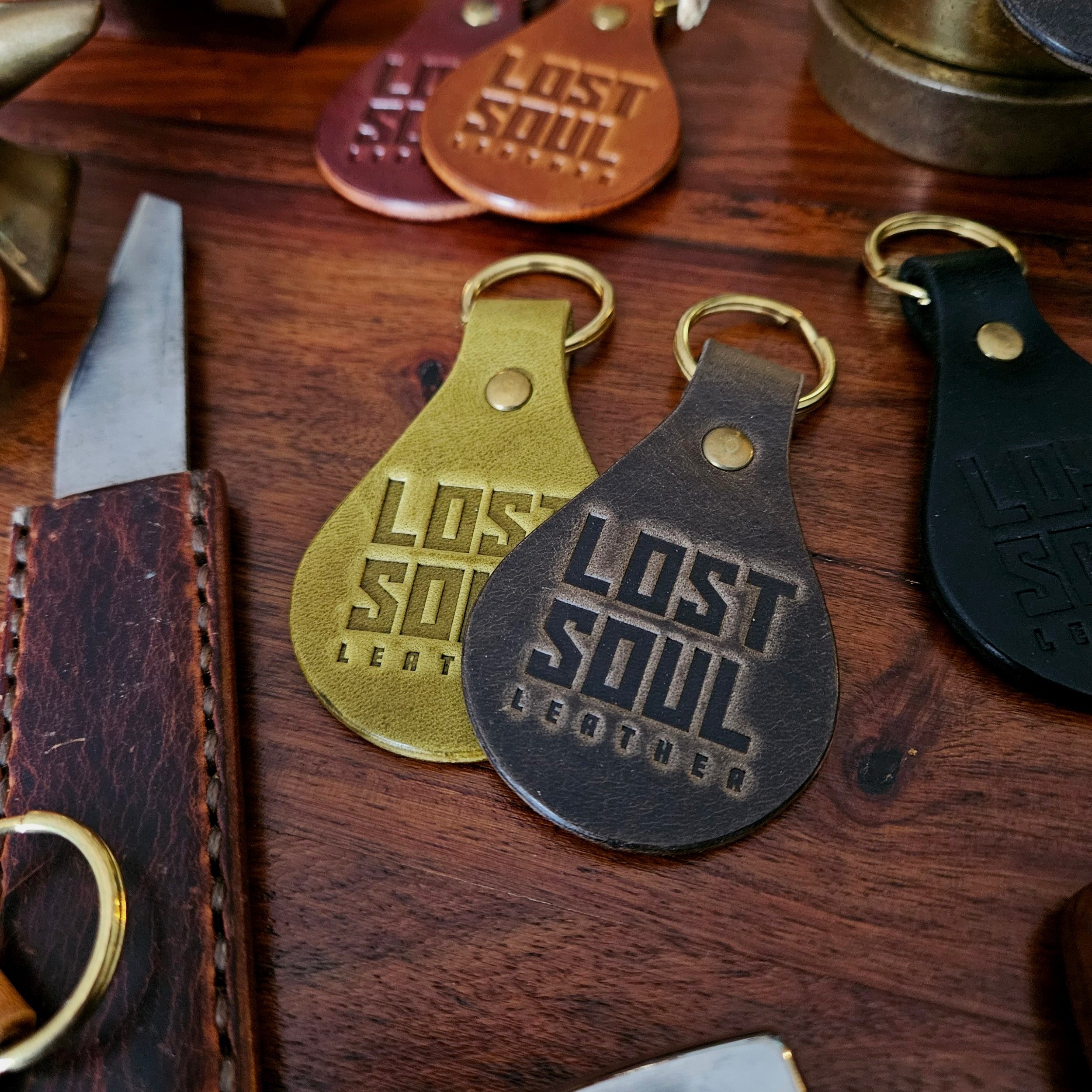 Banded key fobs and merchandise. Vegetable tanned leather. Stamped. Solid brass fittings. One of a kind. Merchandise.