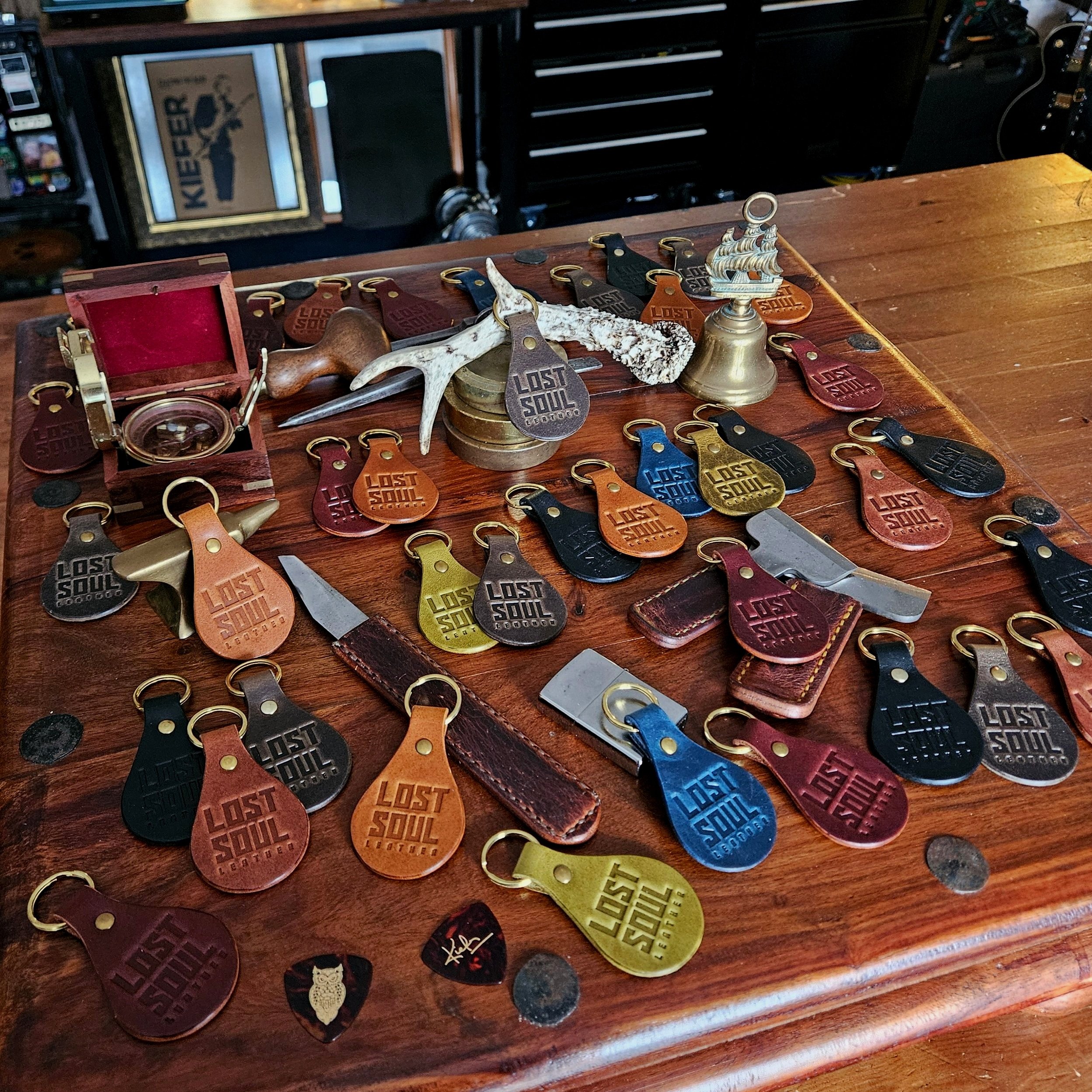 Banded key fobs and merchandise. Vegetable tanned leather. Stamped. Solid brass fittings. One of a kind. Merchandise.
