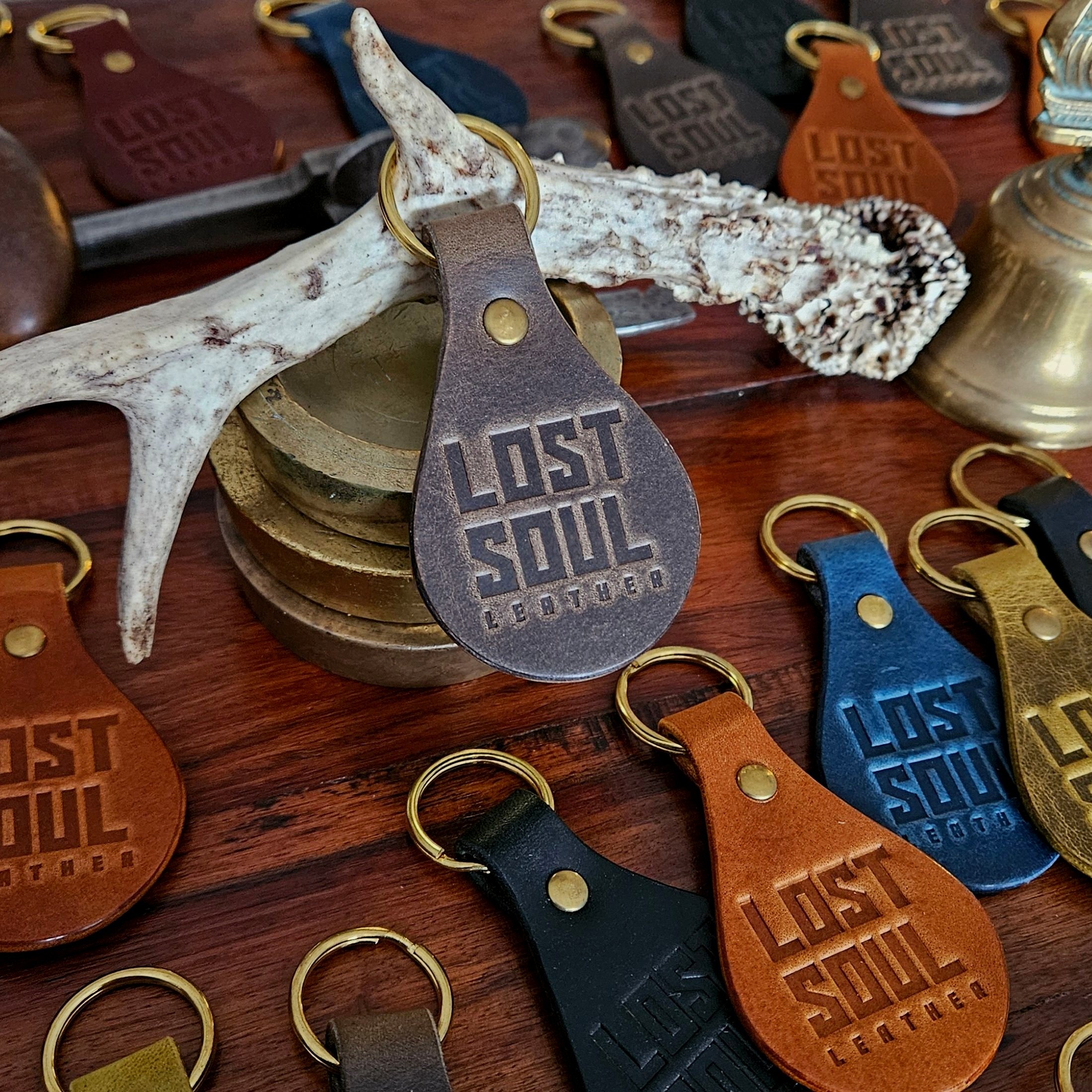 Banded key fobs and merchandise. Vegetable tanned leather. Stamped. Solid brass fittings. One of a kind. Merchandise.