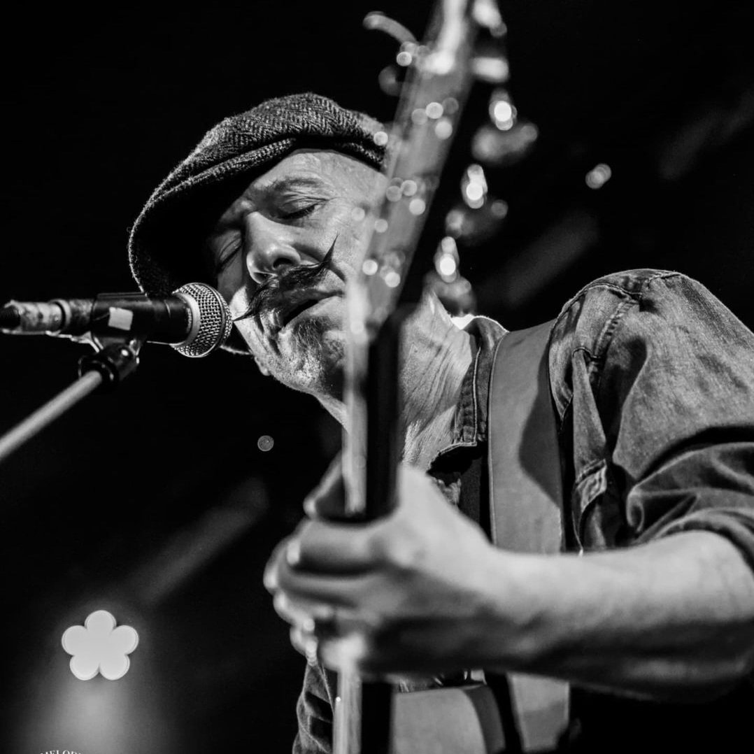 Foy Vance playing guitar on stage using handmade Lost Soul Leather guitar strap.
