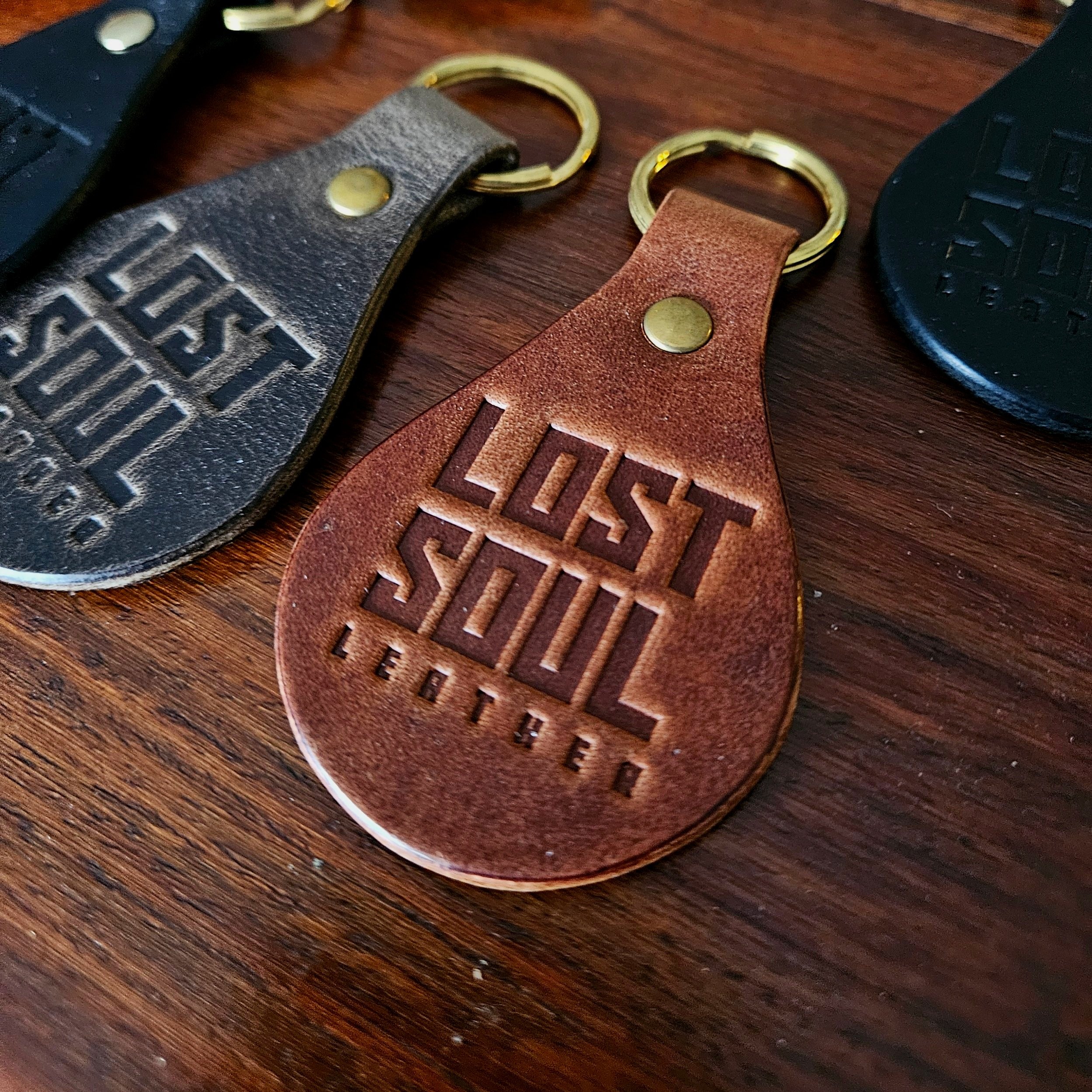 Banded key fobs and merchandise. Vegetable tanned leather. Stamped. Solid brass fittings. One of a kind. Merchandise.