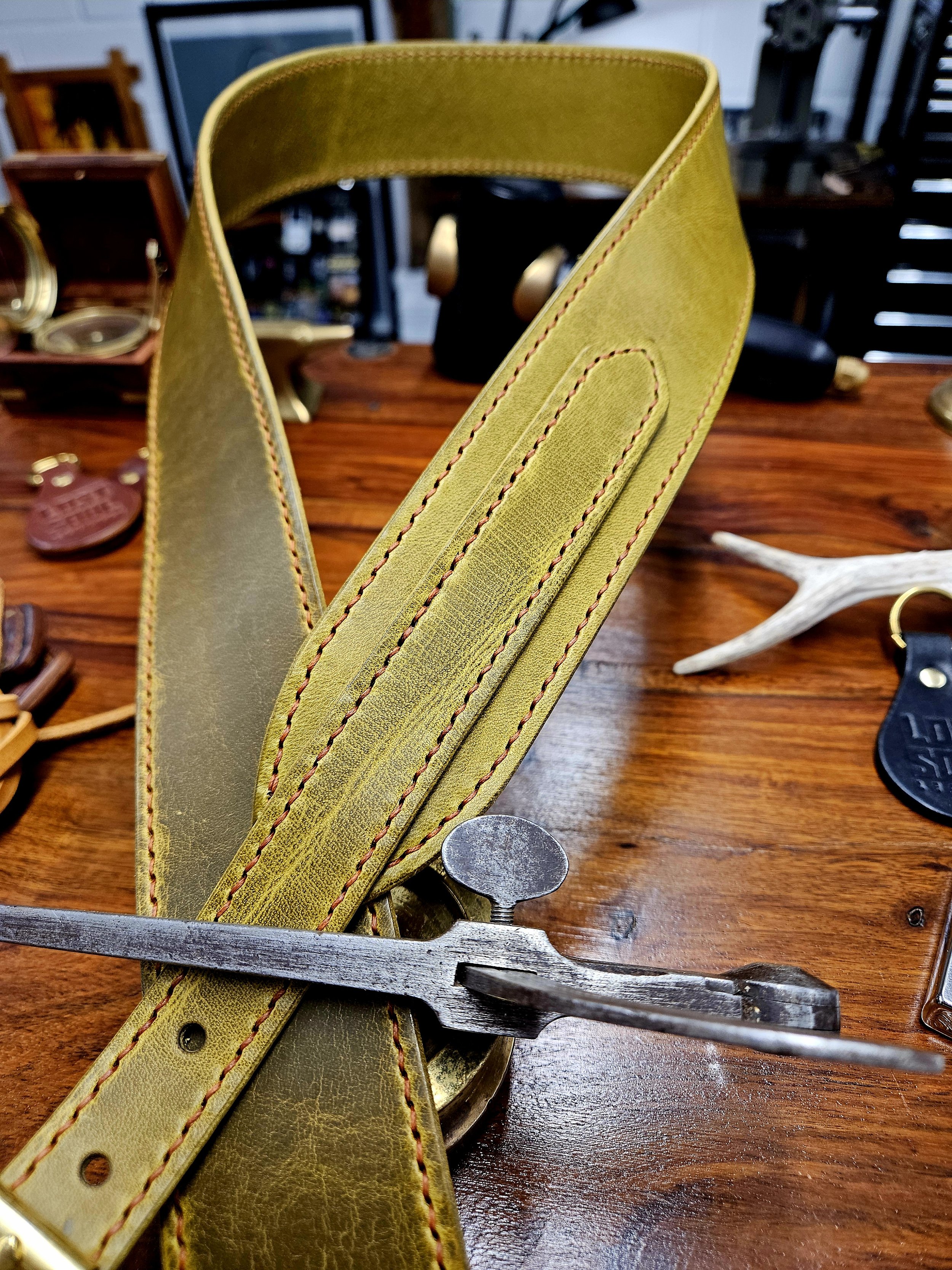 Hand made leather guitar strap. Hand stitched. Solid brass buckle. Made in UK.
