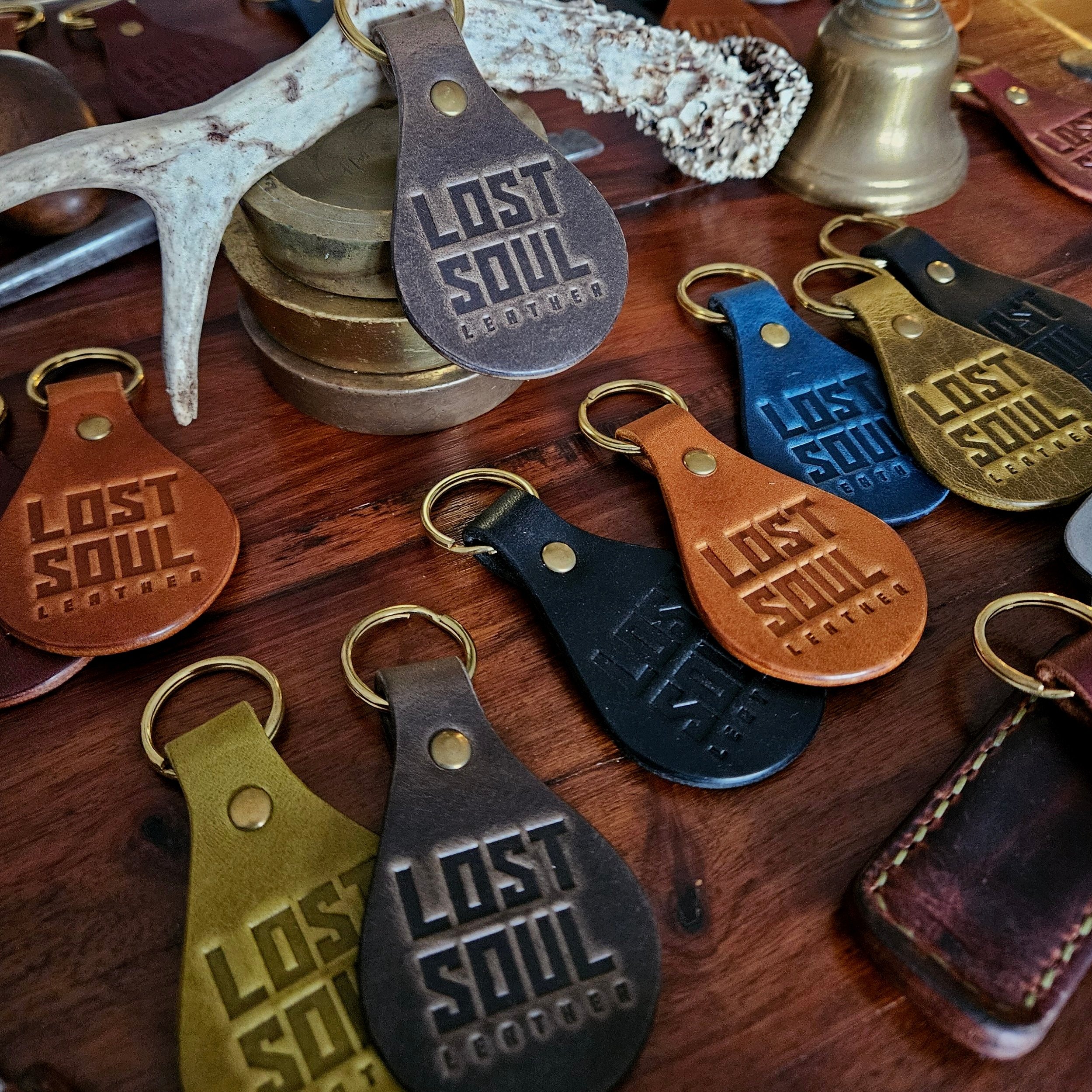 Banded key fobs and merchandise. Vegetable tanned leather. Stamped. Solid brass fittings. One of a kind. Merchandise.