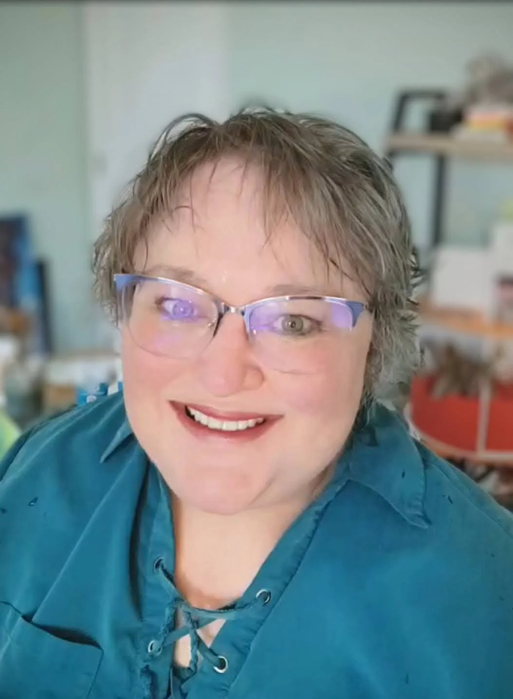 closeup photo of Lori Poff Kellogg in a teal shirt and glasses