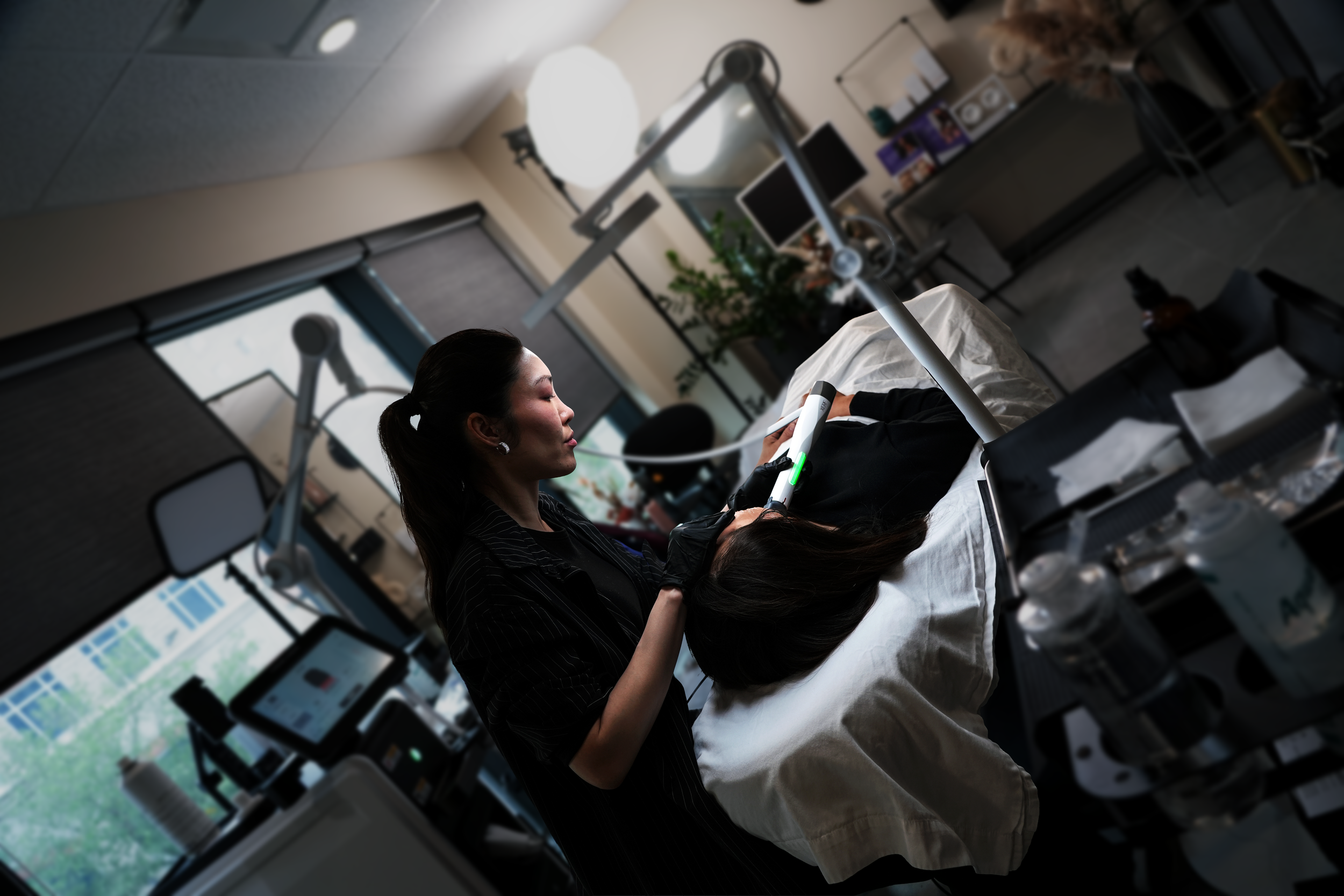 Provider performing a personalized laser skin treatment at SKYNS laser and skin clinic in Calgary.