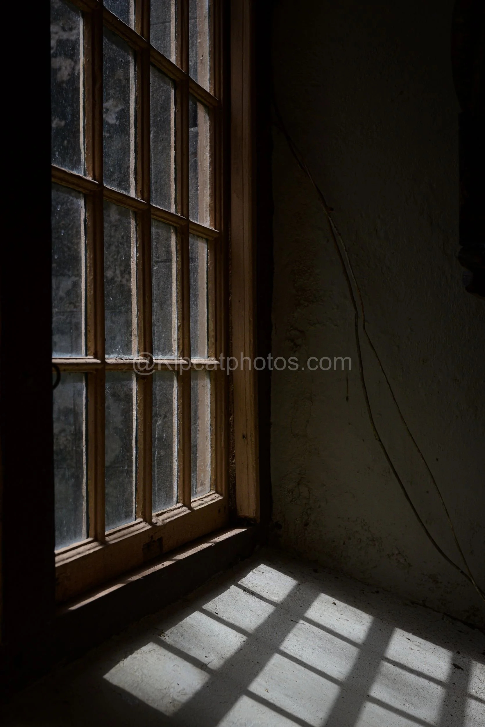 A pair of old multi-pane windows inside St John's Church, Barbados, with hanging cords and a garden visible beyond. Kipcatphotos.com

Weathered sash windows inside St John's Church frame a hazy view of trees and tropical foliage, with loose cords han