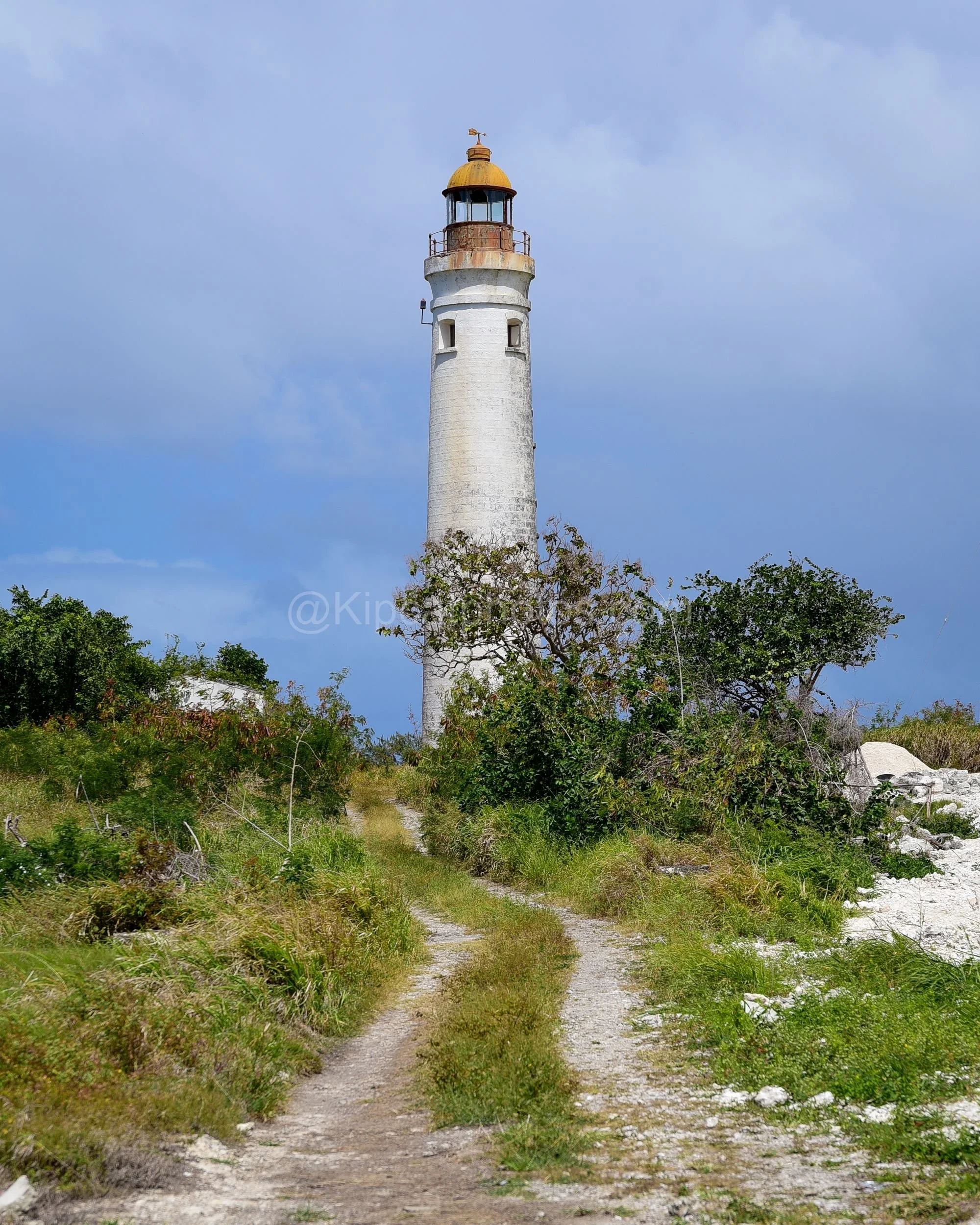 Harrison's lighthouse with a rusted dome rising above a grassy track in Barbados. Kipcatphotos.com

A rough grass and coral track leads up to Harrison's lighthouse, its weathered lantern room capped with a rust-streaked dome standing out against the 