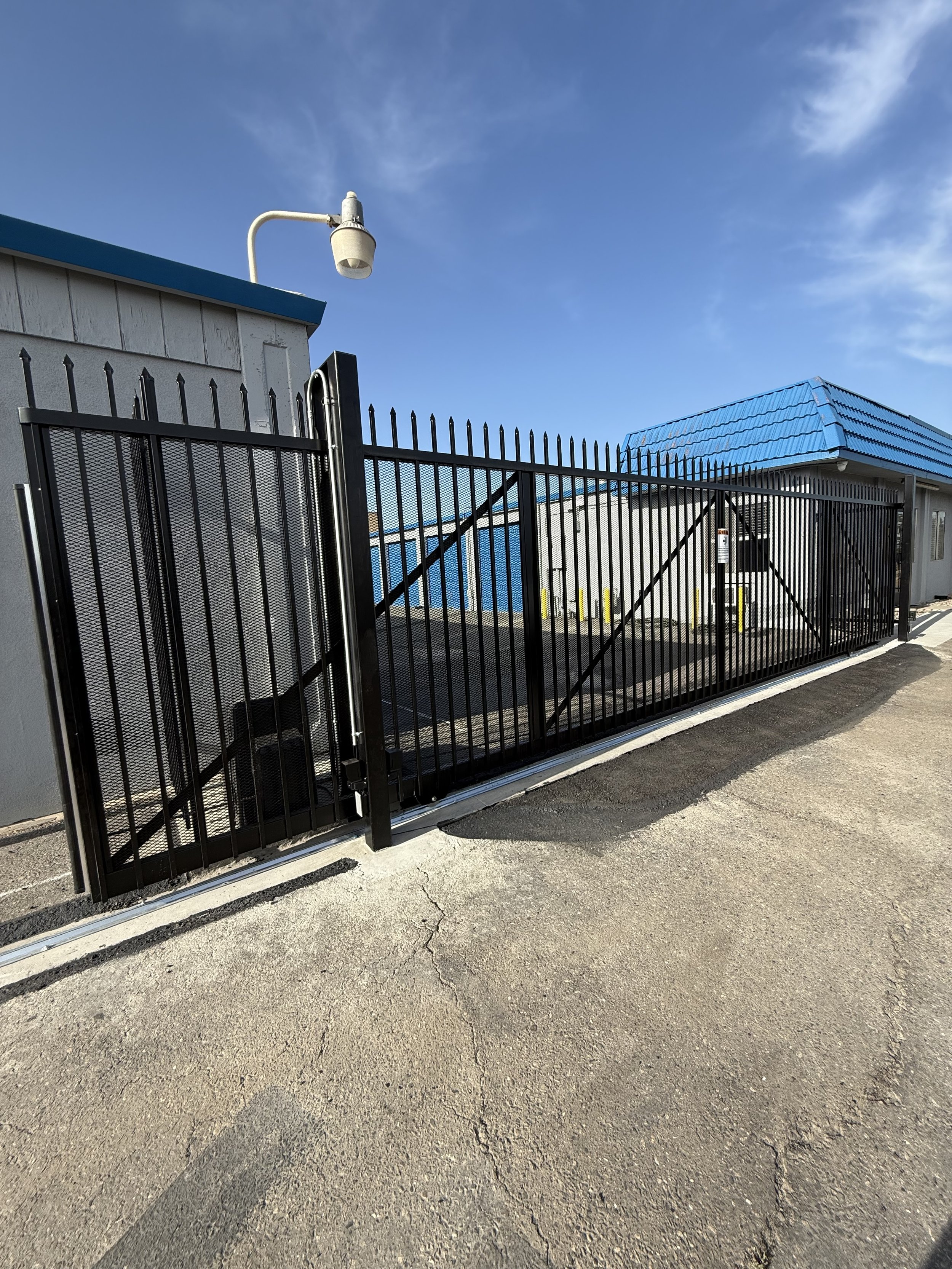 Commercial automated slide gate with custom steel frame at industrial property in Sacramento